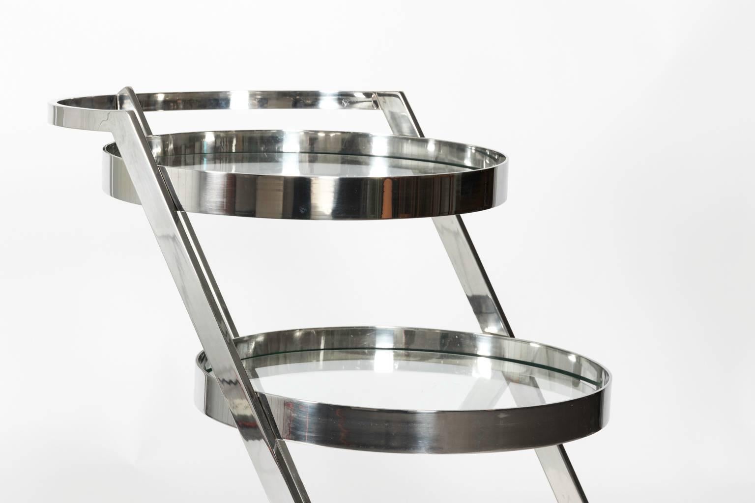 1960's Mid-Century Modern three tier glass and chrome circular bar cart.
