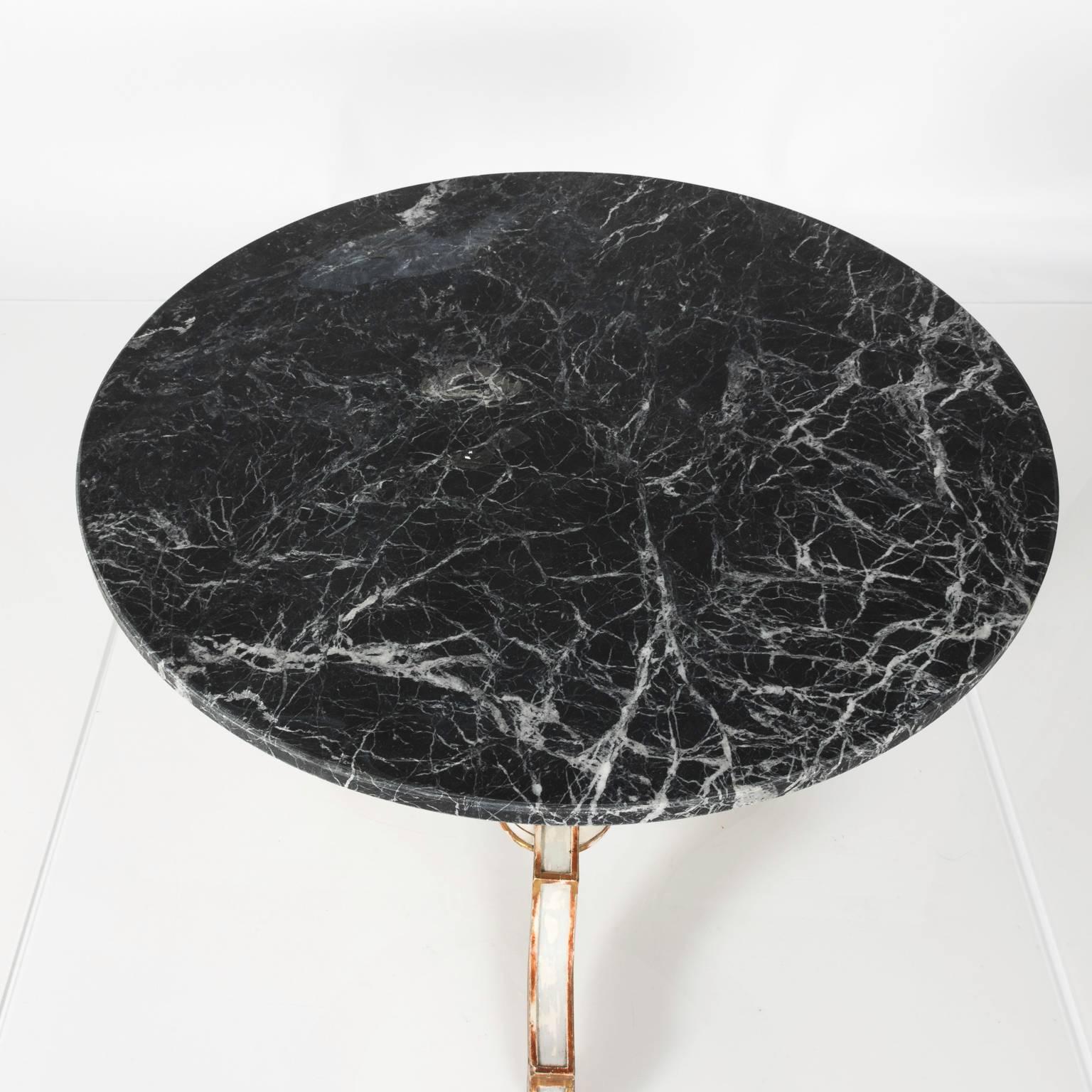 Neoclassical round marble-top pedestal side table with Greek key motif antiqued finish and gilded decor.