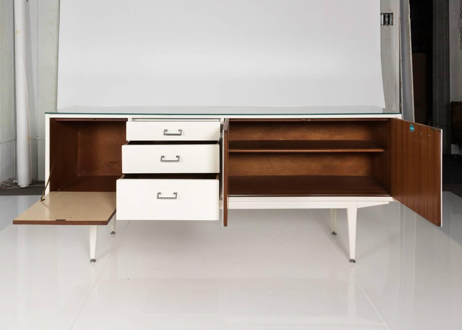 Mid-Century Modern lacquered sideboard with two doors and three drawers.
 