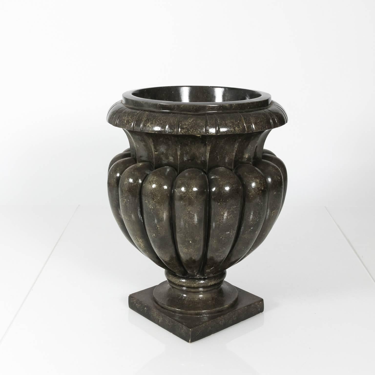 Pair of light weight composite urns with faux granite trompe l'oile finish. 
