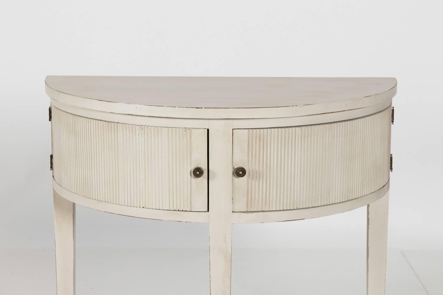 Gustavian style painted demilune table with two doors and plain tapered legs, circa mid-20th century.
 