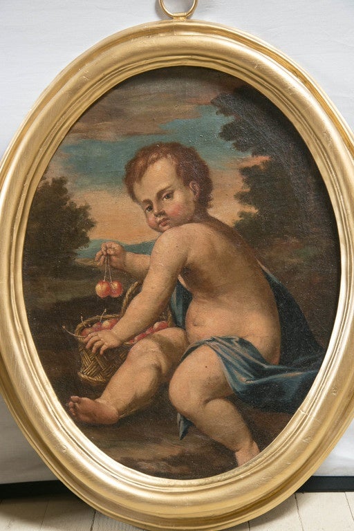 Each are set within a painted gold frame with ring top. One putto faces to the right, the other to the left. Each are cloth draped within a landscape setting. The each hold from their fingers bunches of fruit.
They are unsigned.