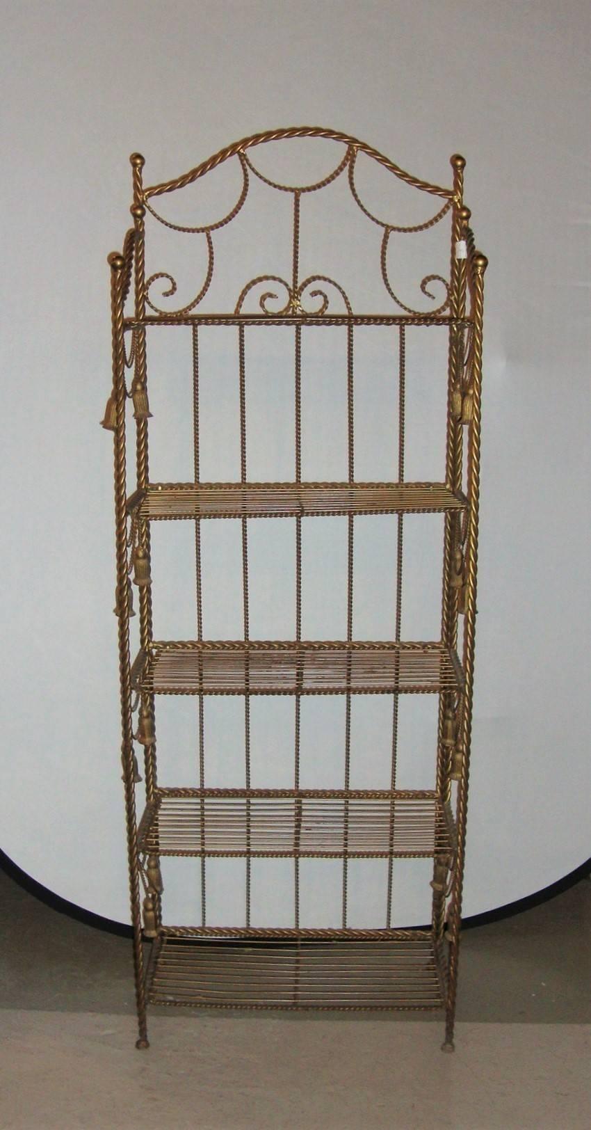 A fold-away brass tastle form five shelf étagère.