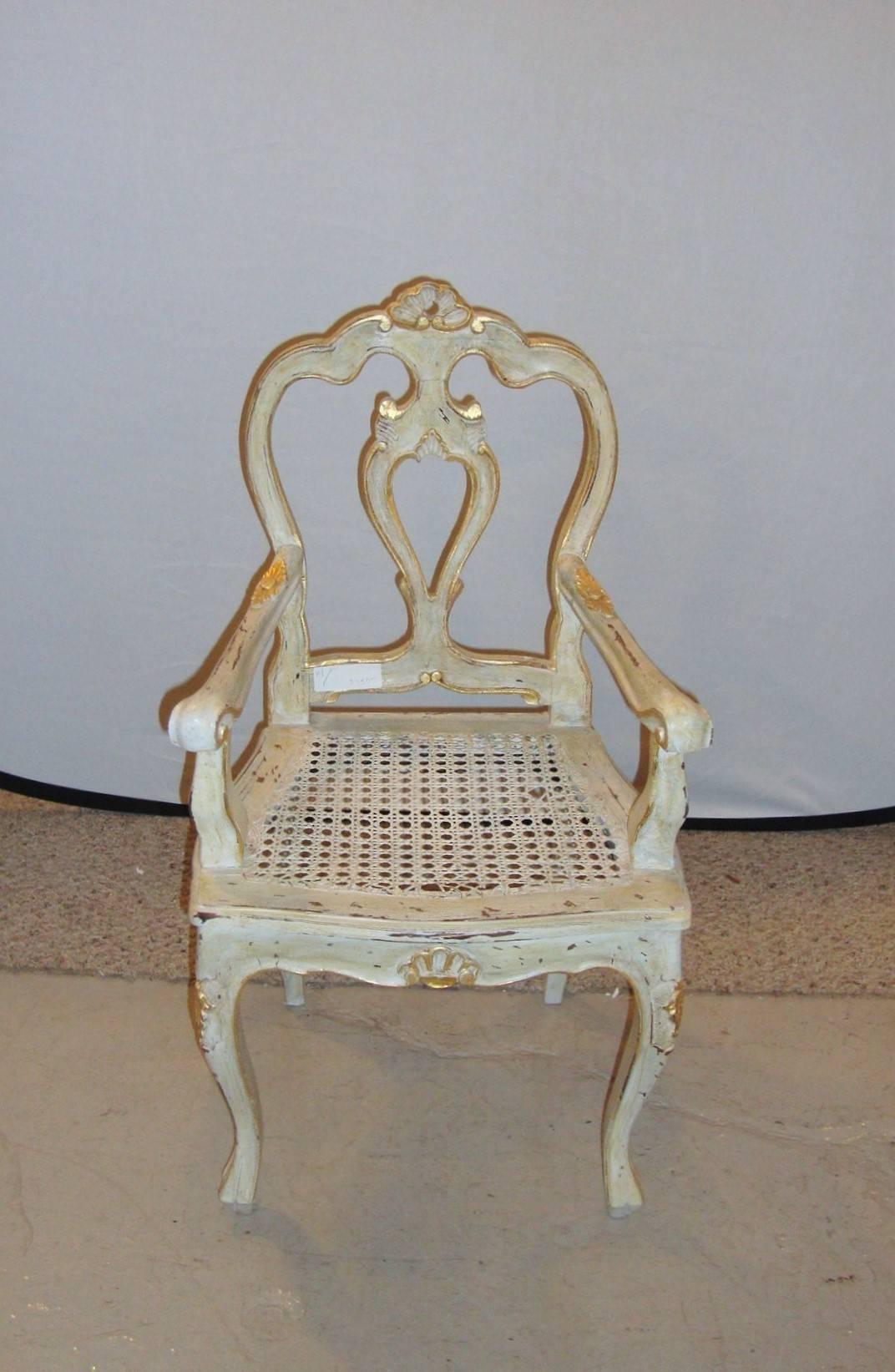 Paint and gilt decorated armchair Louis XV style. Fine child's or doll chair in white finish with gilt highlights fashioned in the Louis XV style. This finely distressed armchair is very decorative.

  