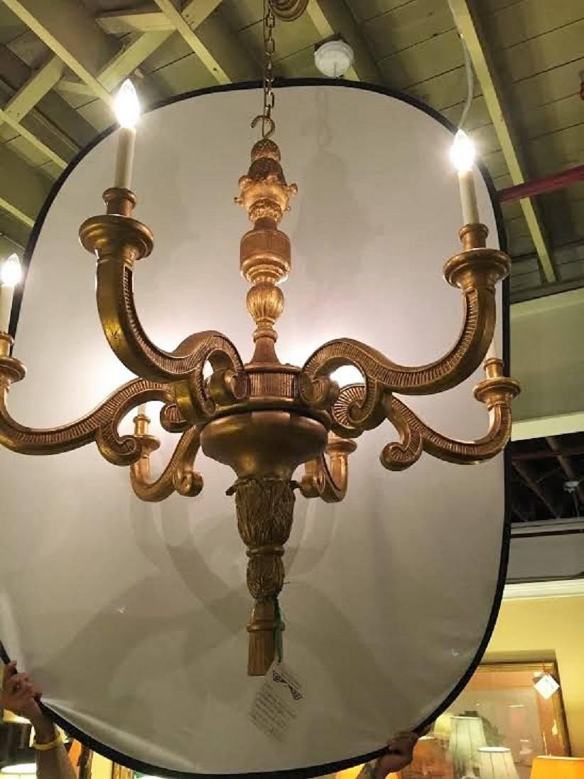 An Italian Louis XVI fashioned six light large chandelier. The ribbon and tassel form centre column having six reeded arms flowing from the stem. The whole terminating in an acorn. Large and Impressive recently rewired chandelier. All wooded having