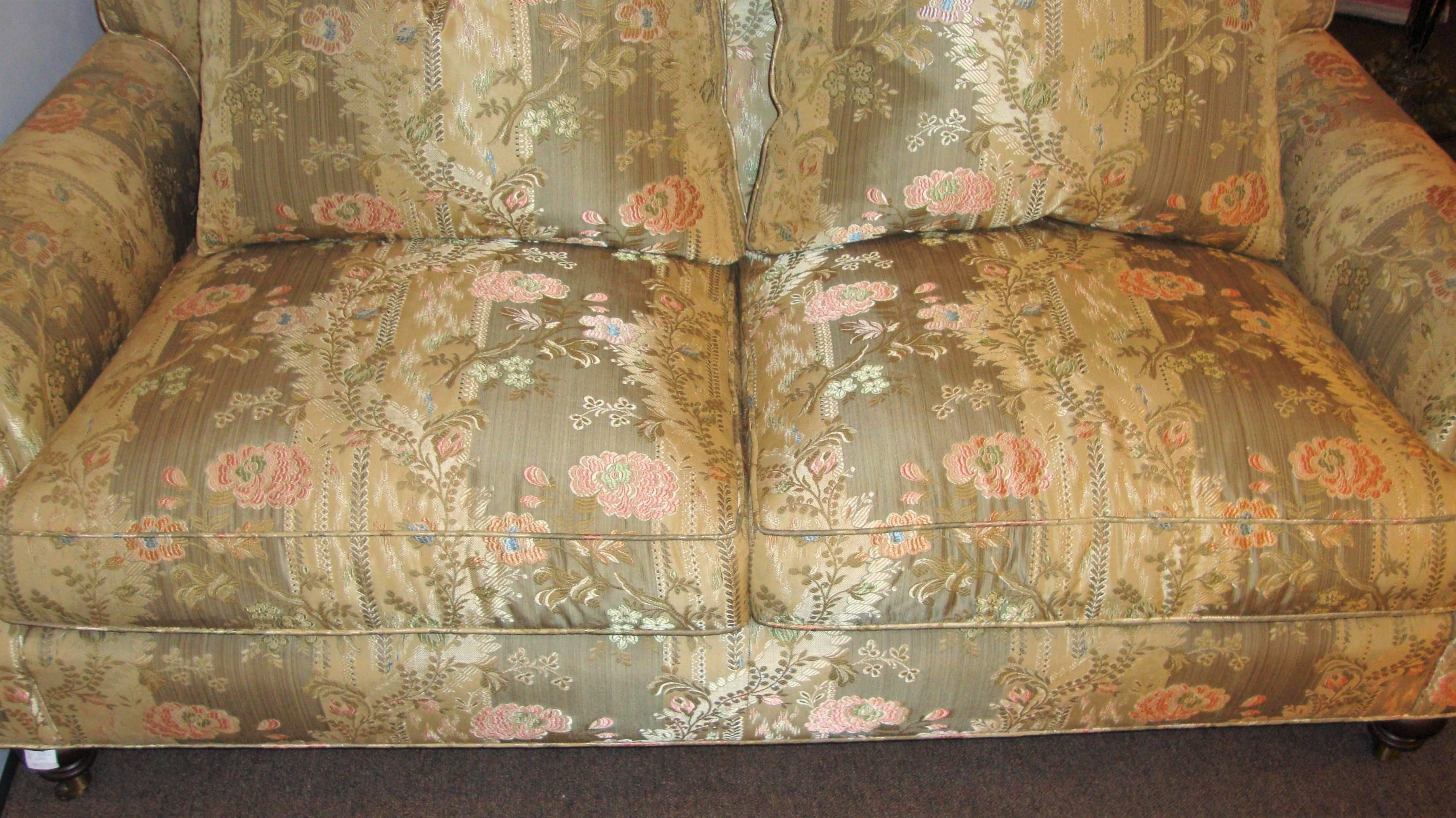 A pair of oversized Edward Ferrell signed floral print loveseats. These super comfy couches bring two matching back pillows each supported by bun feet on casters. Finest quality by one of the hottest designers. Directly from an North Shore Long