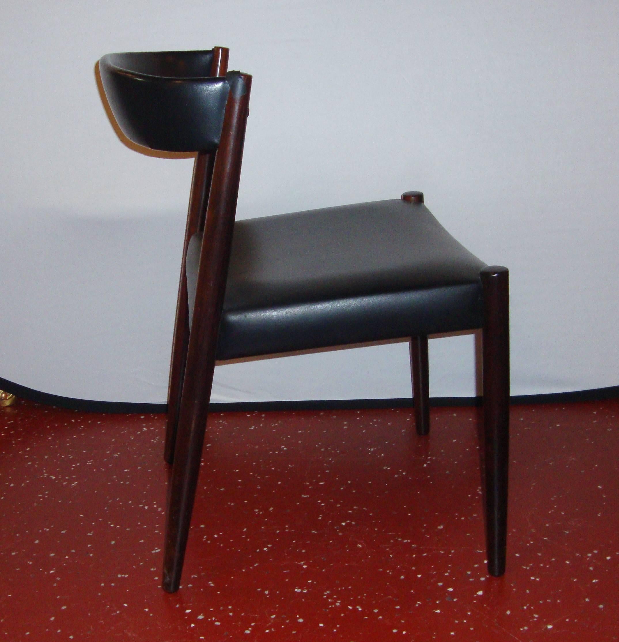 A pair of custom quality Danish modern side chairs. The black leather seats and curved backrests make for comfort and look wonderful on these very sleek and stylish side or office chairs. The wood frames having been recently polished and waxed.