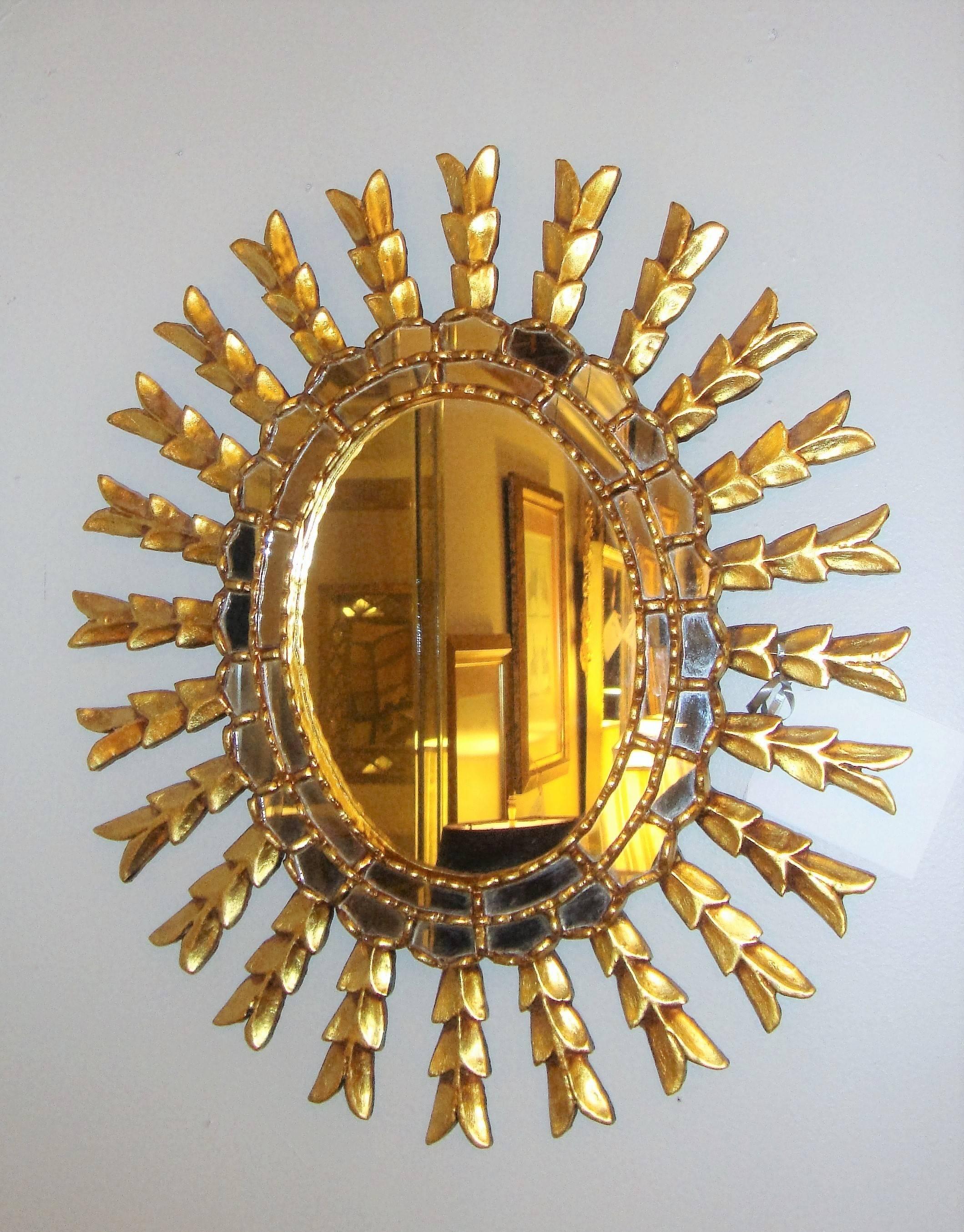 Sunburst style arrow form giltwood wall mirror.