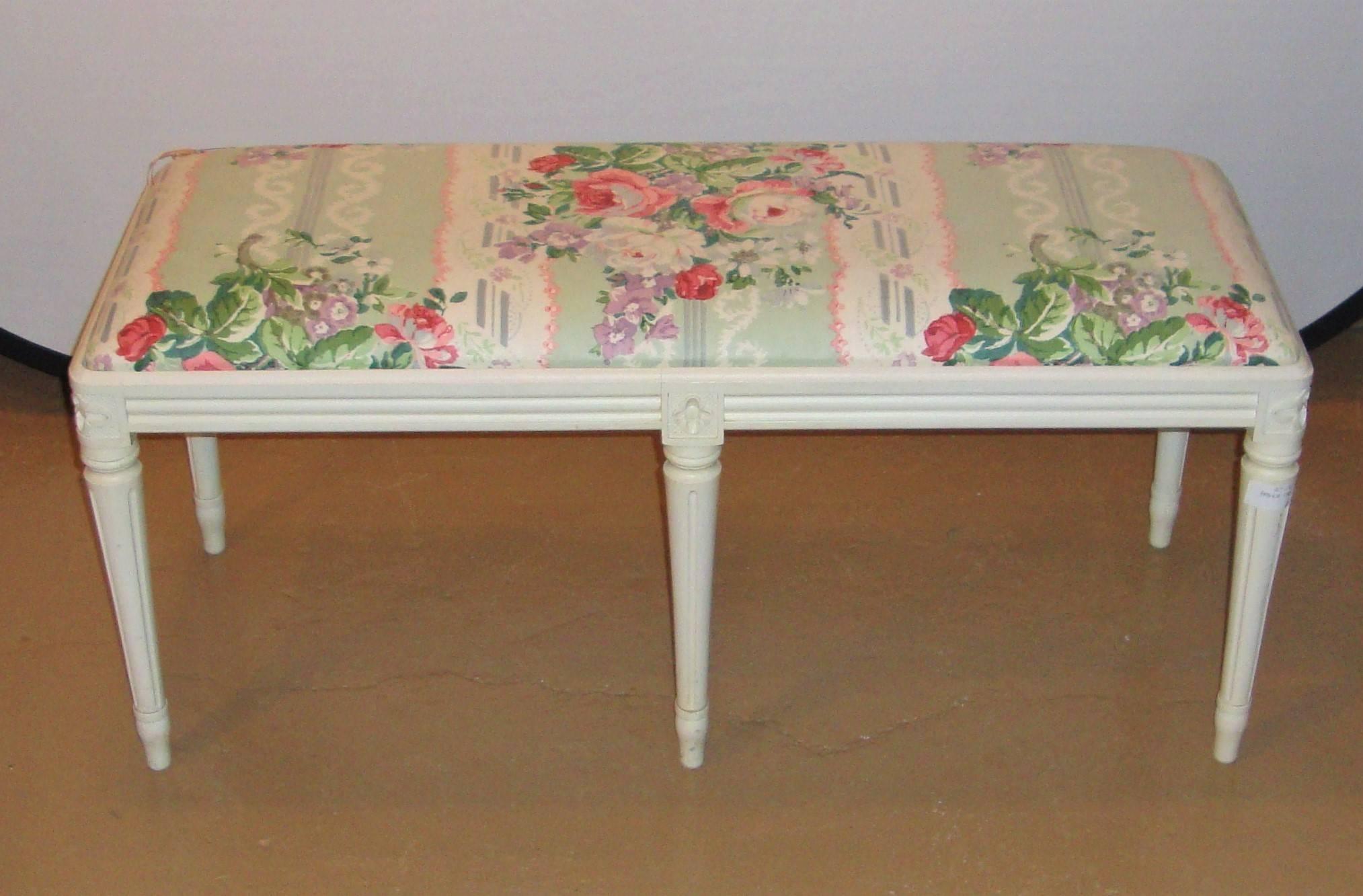 Louis XVI Style Paint Decorated Window Bench. An off-white painted window bench fashioned in the Louis XVI Style. The six legged bench or footstool having a nice floral upholstered stuffed seat. Great for use as a piano bench.