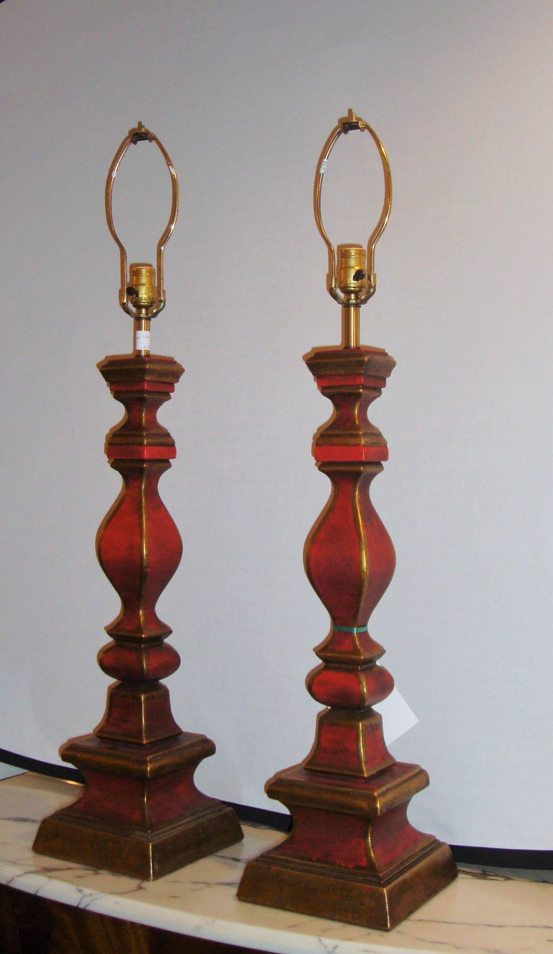 An elegant pair of vintage Italian table lamps painted in a beautiful gold and red, column form.
    
   