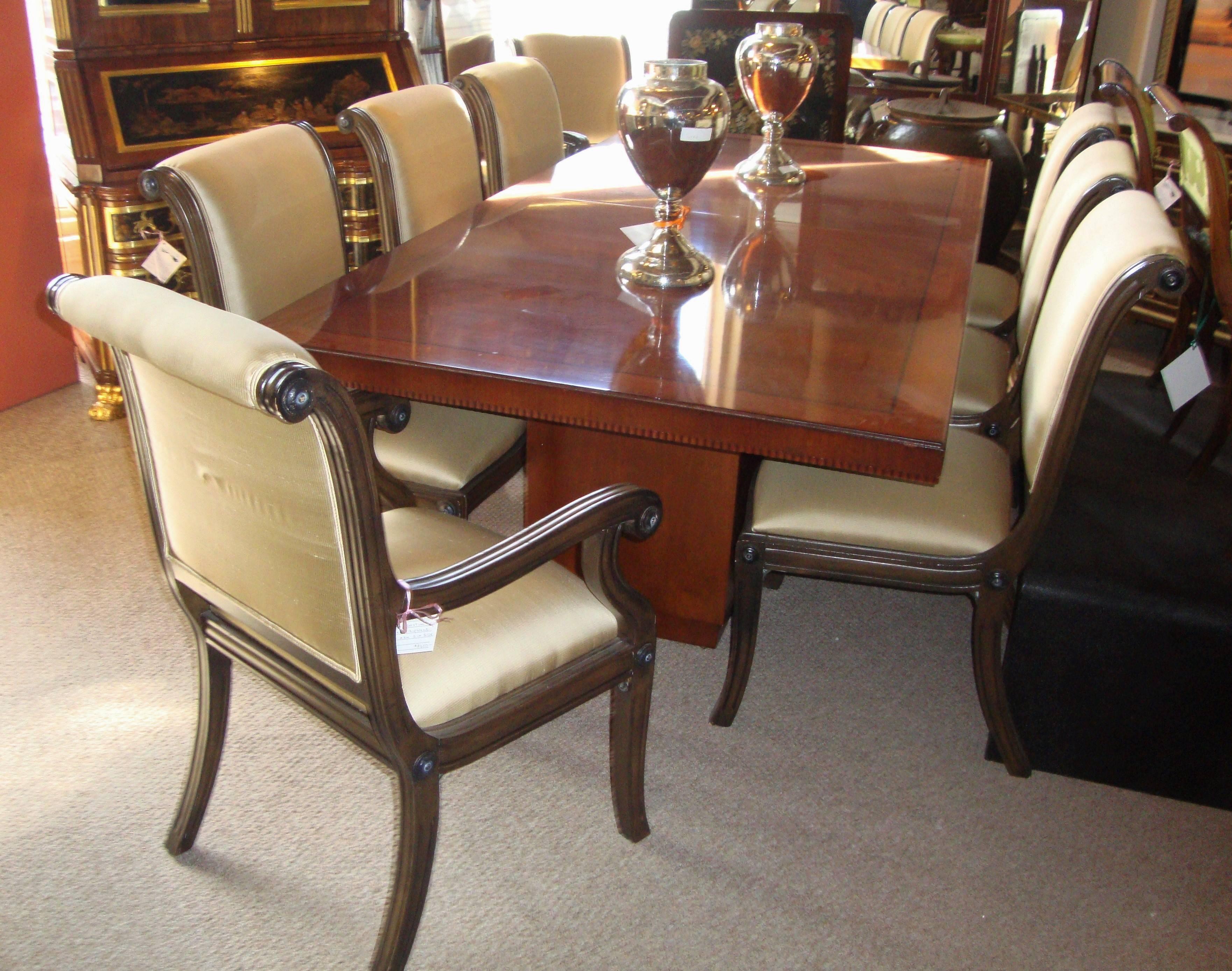 Set of eight sabre leg sleigh back dining chairs.The set comprising of two-arm and a set of six chairs.These finely constructed dining chairs are done in the Hollywood Regency fashion and styled in the copy of Maison Jansen. The sleek lines and