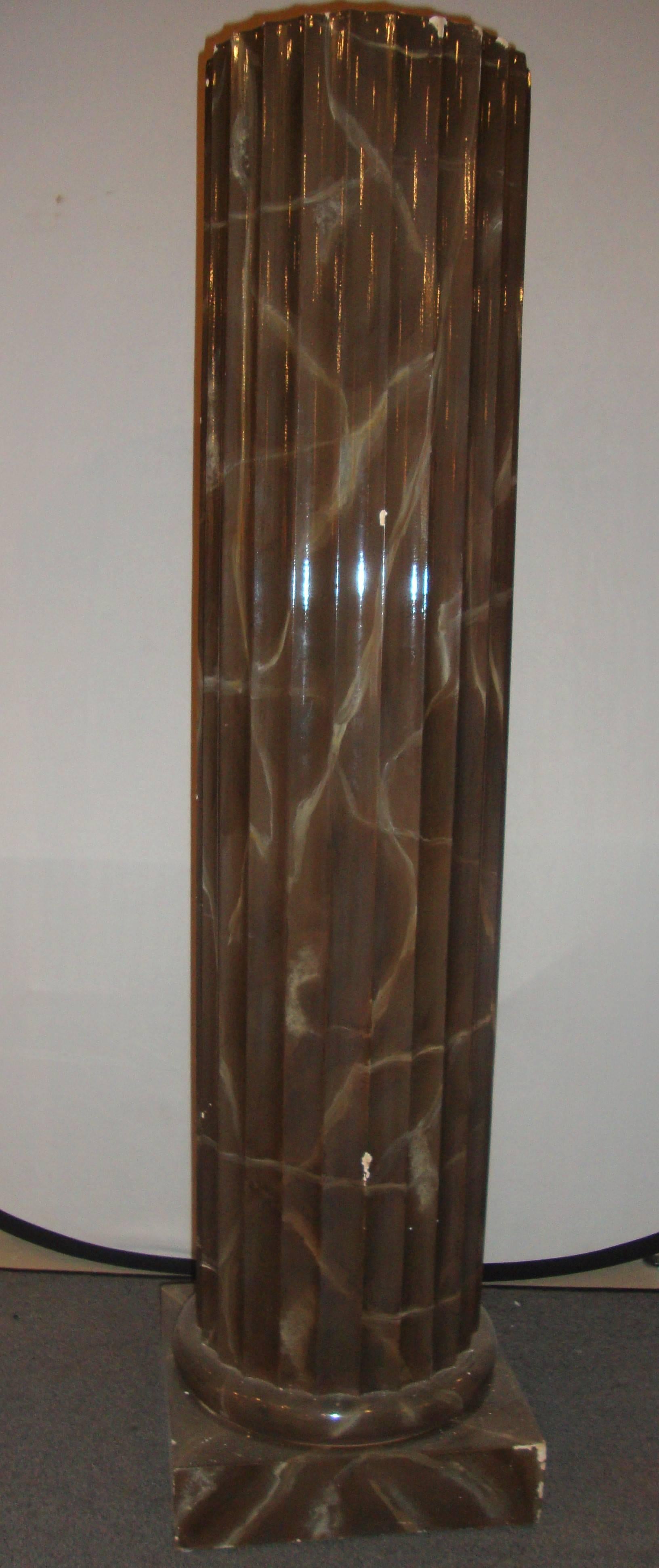 Pair of column style pedestals. The pair of pedestals come in a column style with a brown, marble like appearance.
