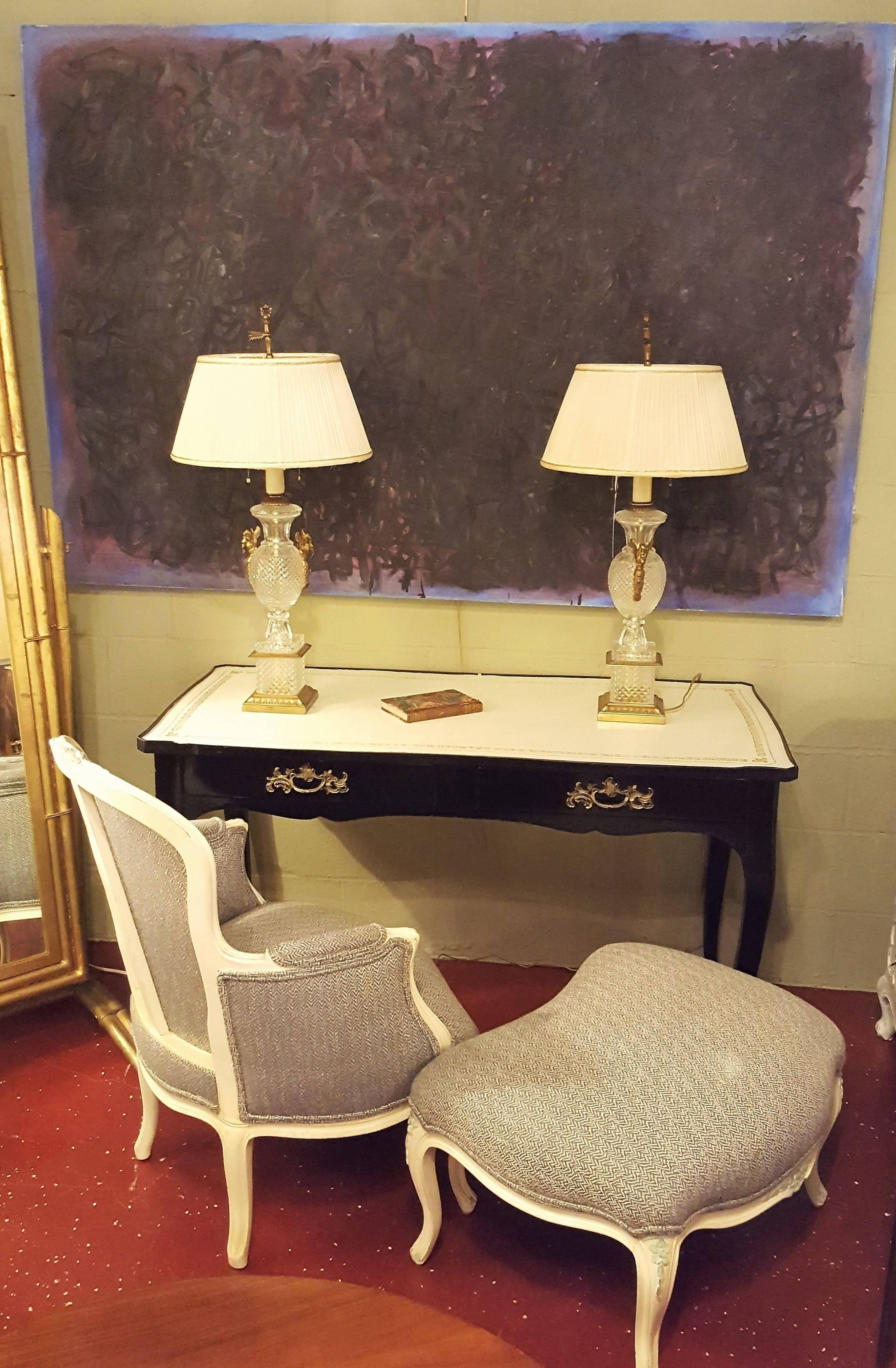 Jacques Bodart stamped ebonized Louis XV style desk. Having two drawers and a white leather top with a gilt decorated frame. Nice bronze feet and drawer pulls.