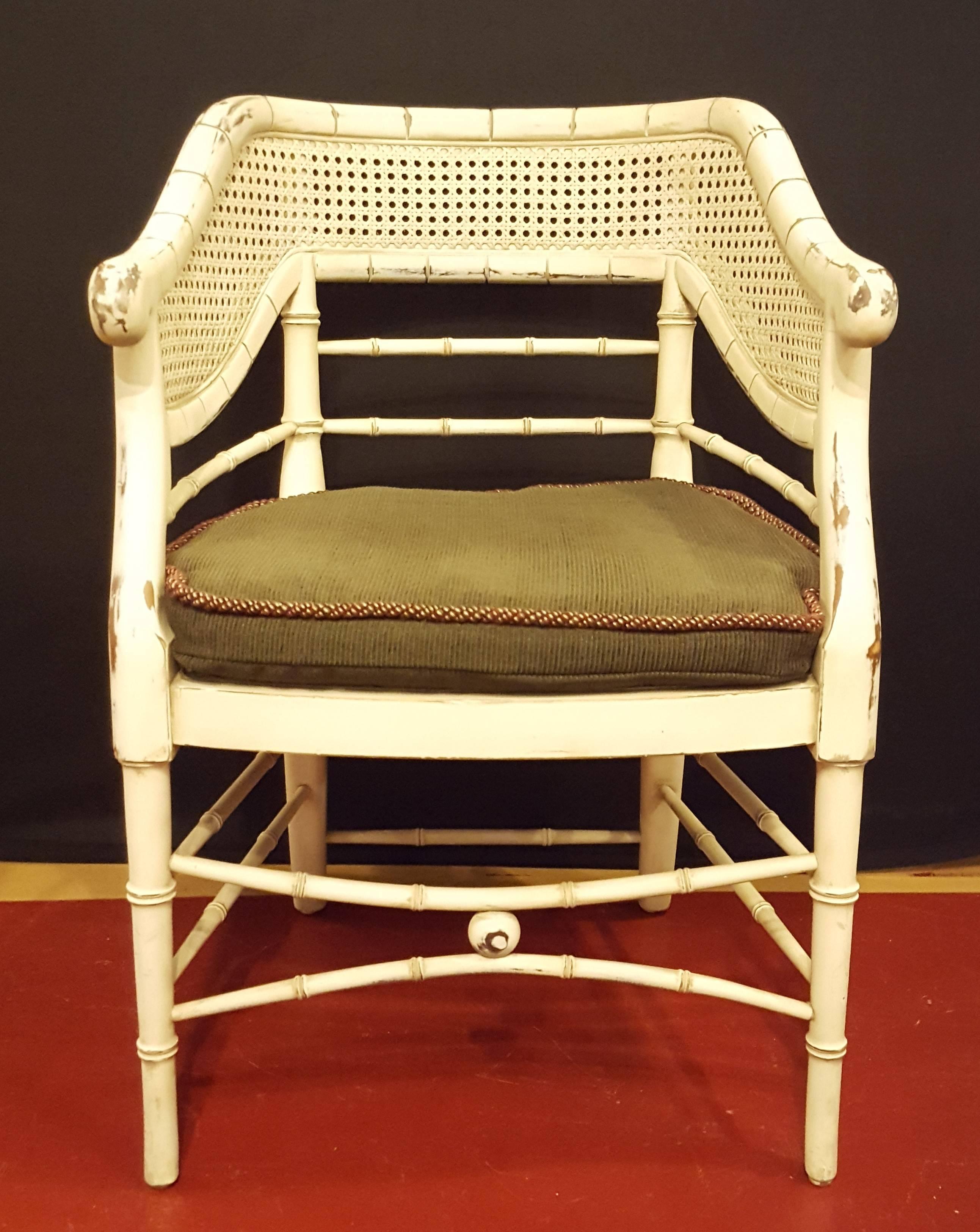 Pair of Mid Century bamboo chairs. In an off-white color, removable cushion, and comfortable curved backs.