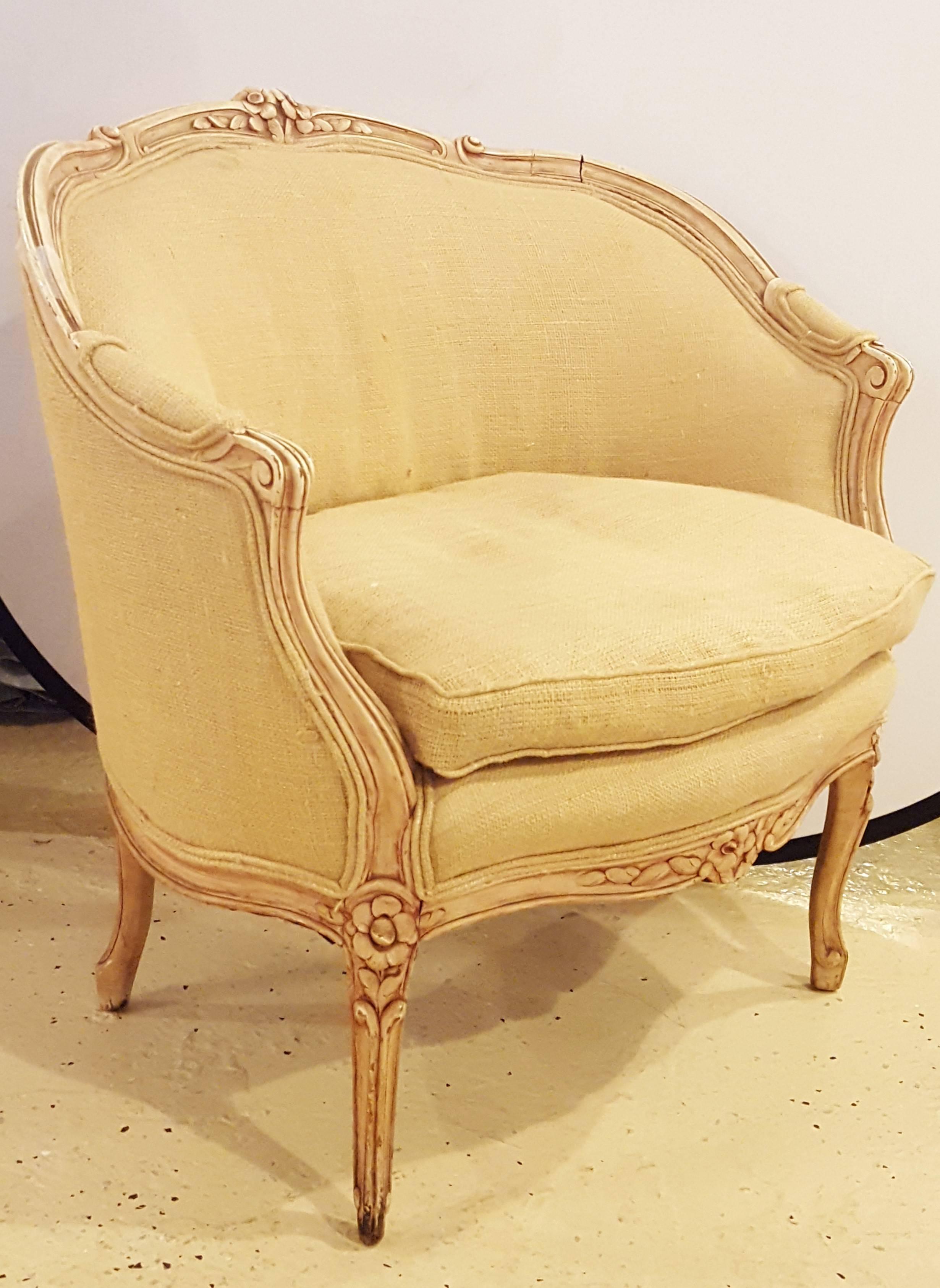 Louis XV style distressed barrel back armchair. Nicely carved frame with rosettes and curved lines.