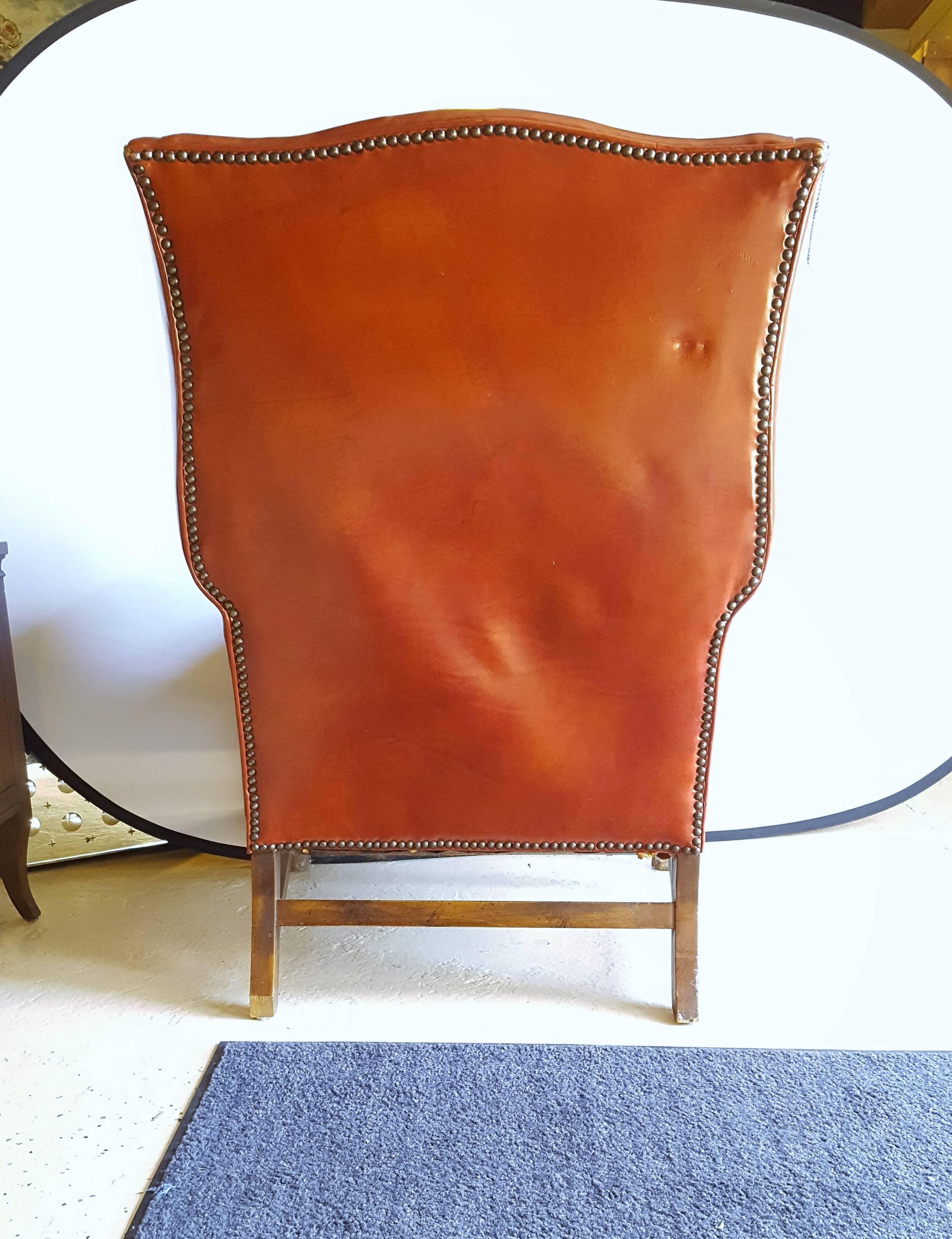 20th Century A Stately Traditional English Red Leather Wing Back Armchair With Nailhead Trim