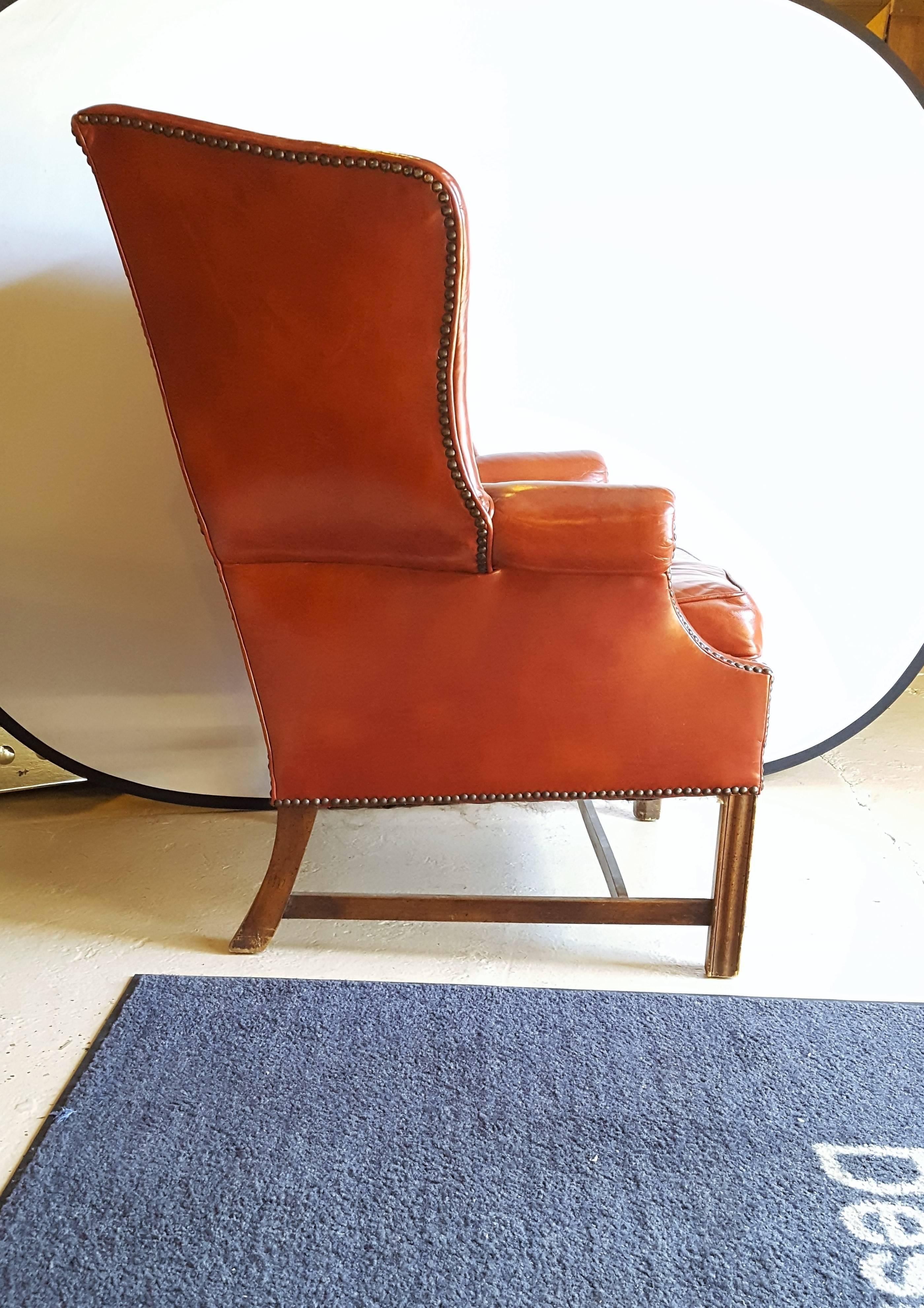 A Stately Traditional English Red Leather Wing Back Armchair With Nailhead Trim In Good Condition In Stamford, CT