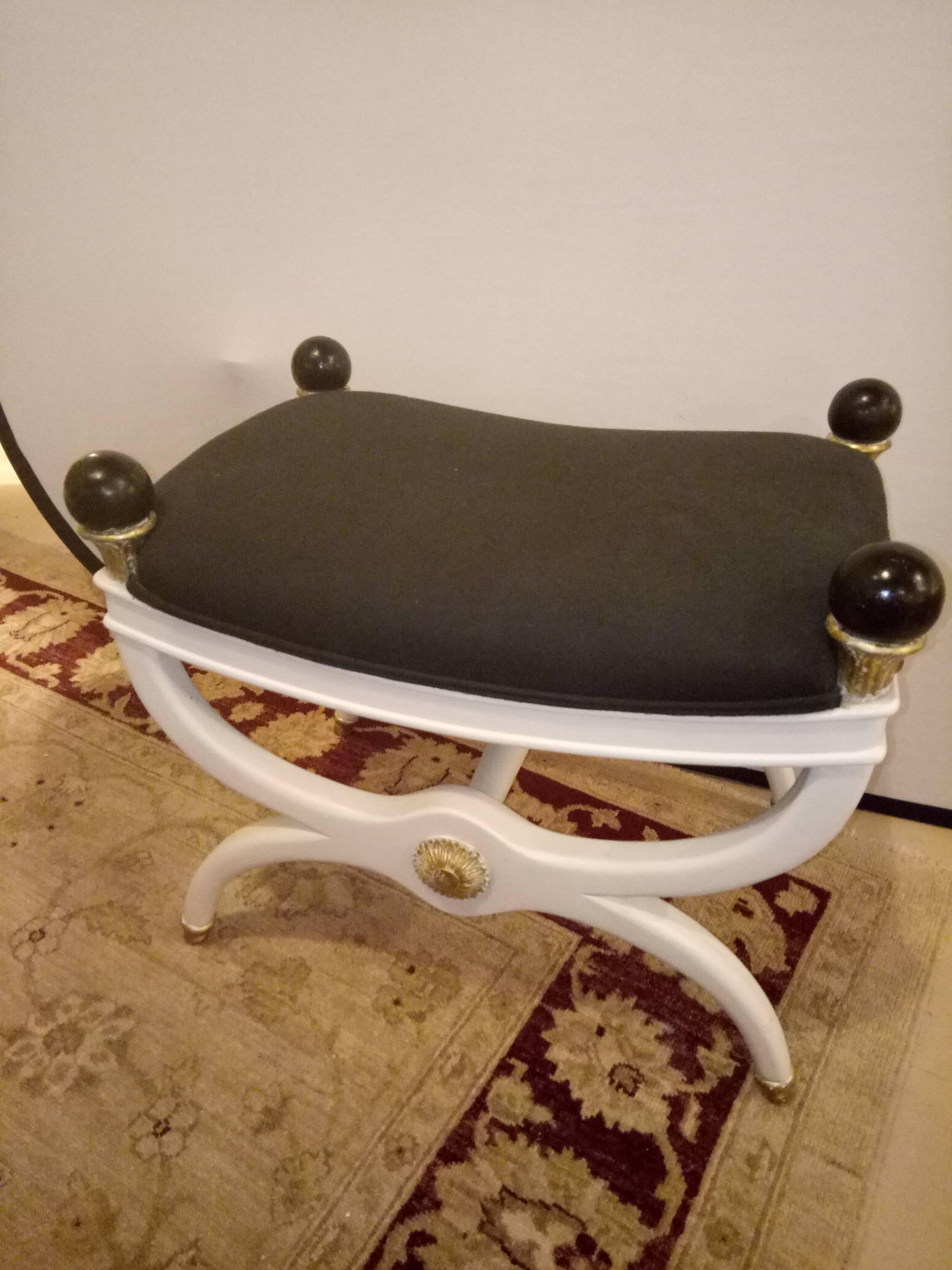 White painted and gilt decorated X from bench / footstool. Highly decorative painted bench footstool in the Hollywood Regency fashion.
