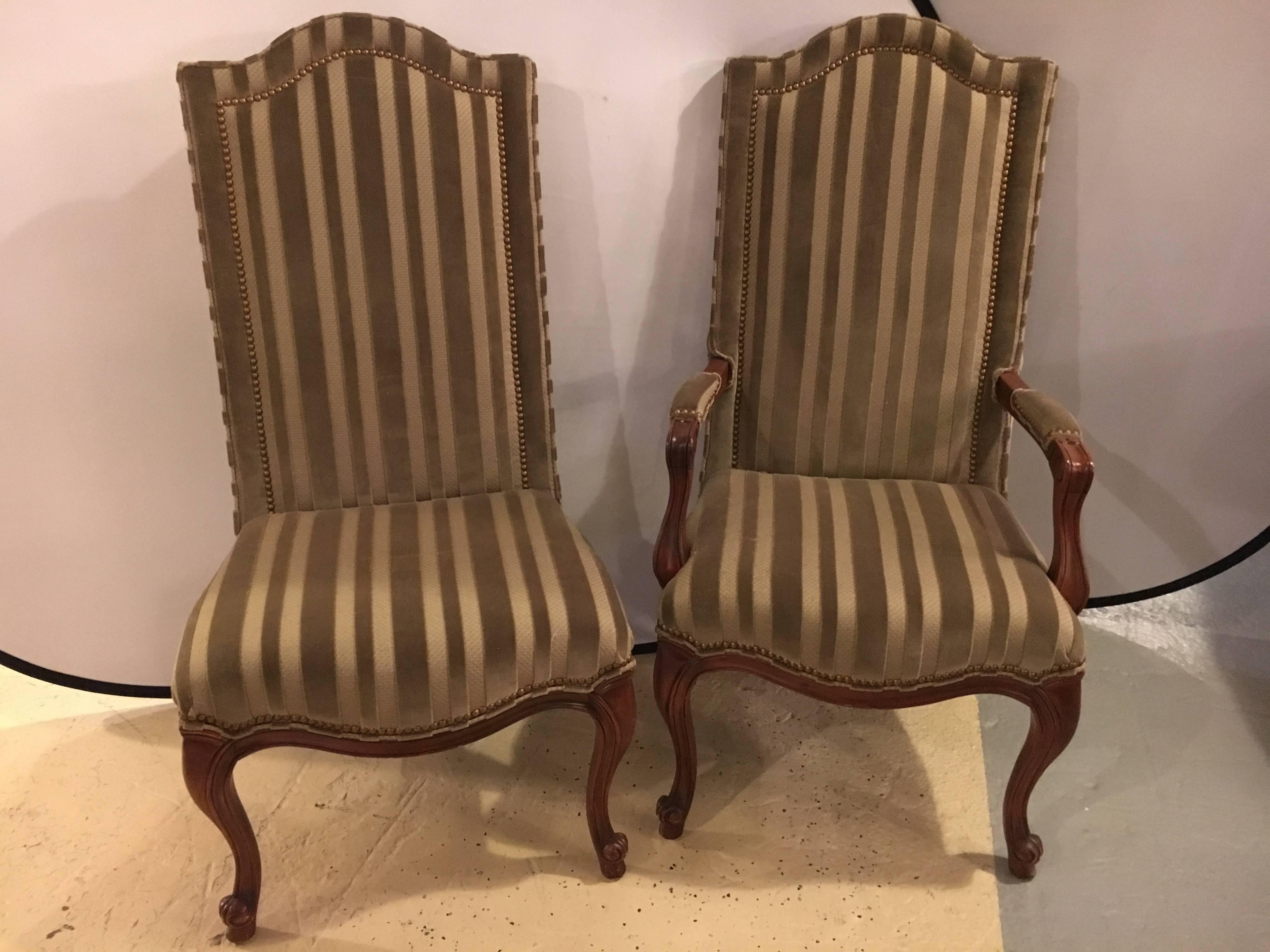 Set of ten harden dining room chairs. Two armchairs and eight side chairs. Each in a clean and lovely stripped green fabric with double tacked frames. The whole resting on Louis XC style legs.
Measurements for armchairs are 47 H 24.5 W 21D.