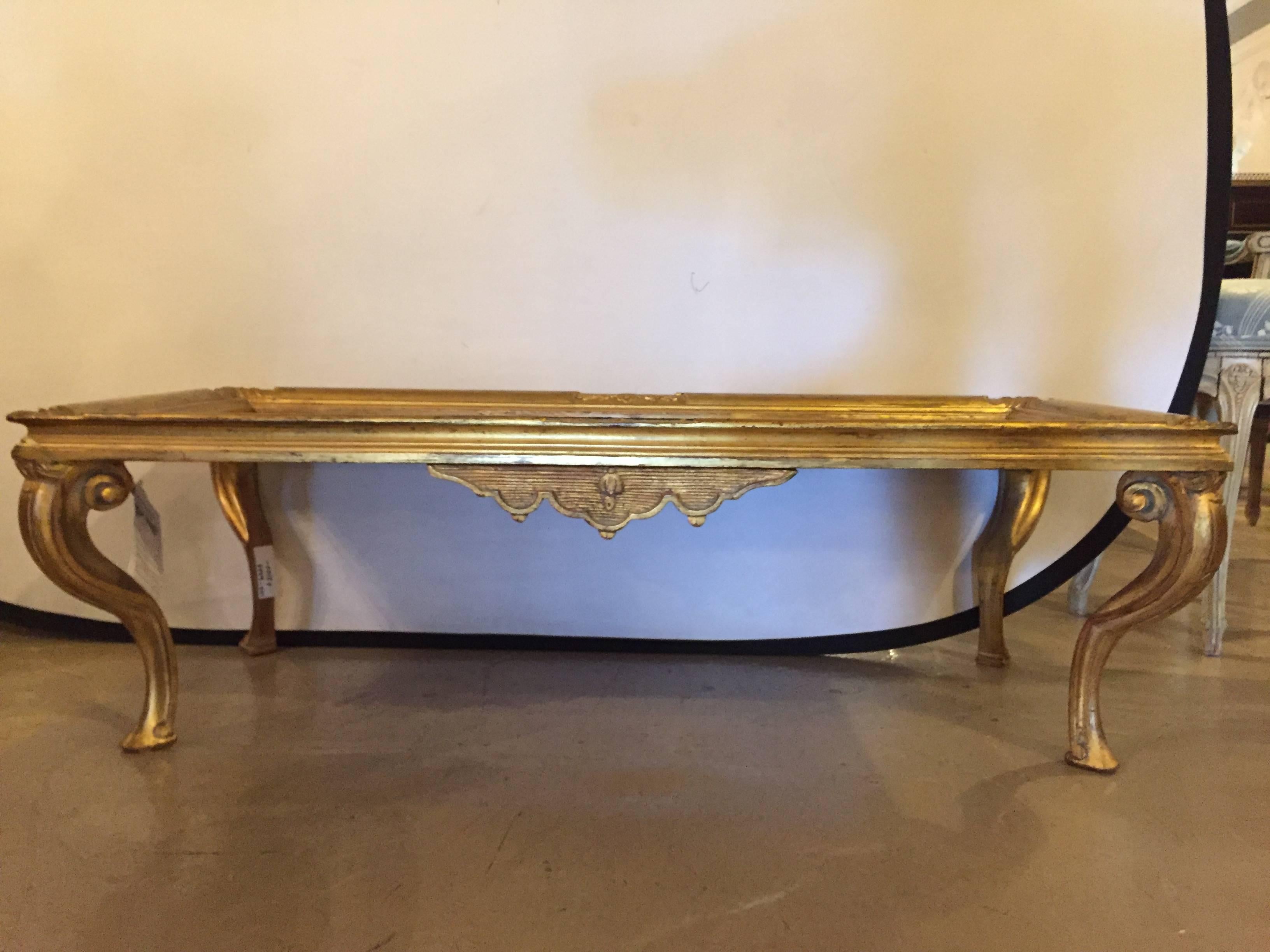 A Louis XV style Chinoiserie gilt base coffee low table. A fine quality giltwood base of carved and routed form supporting a wonderfully detailed table top having an ebonized background depicting a genre of Geishas eating.