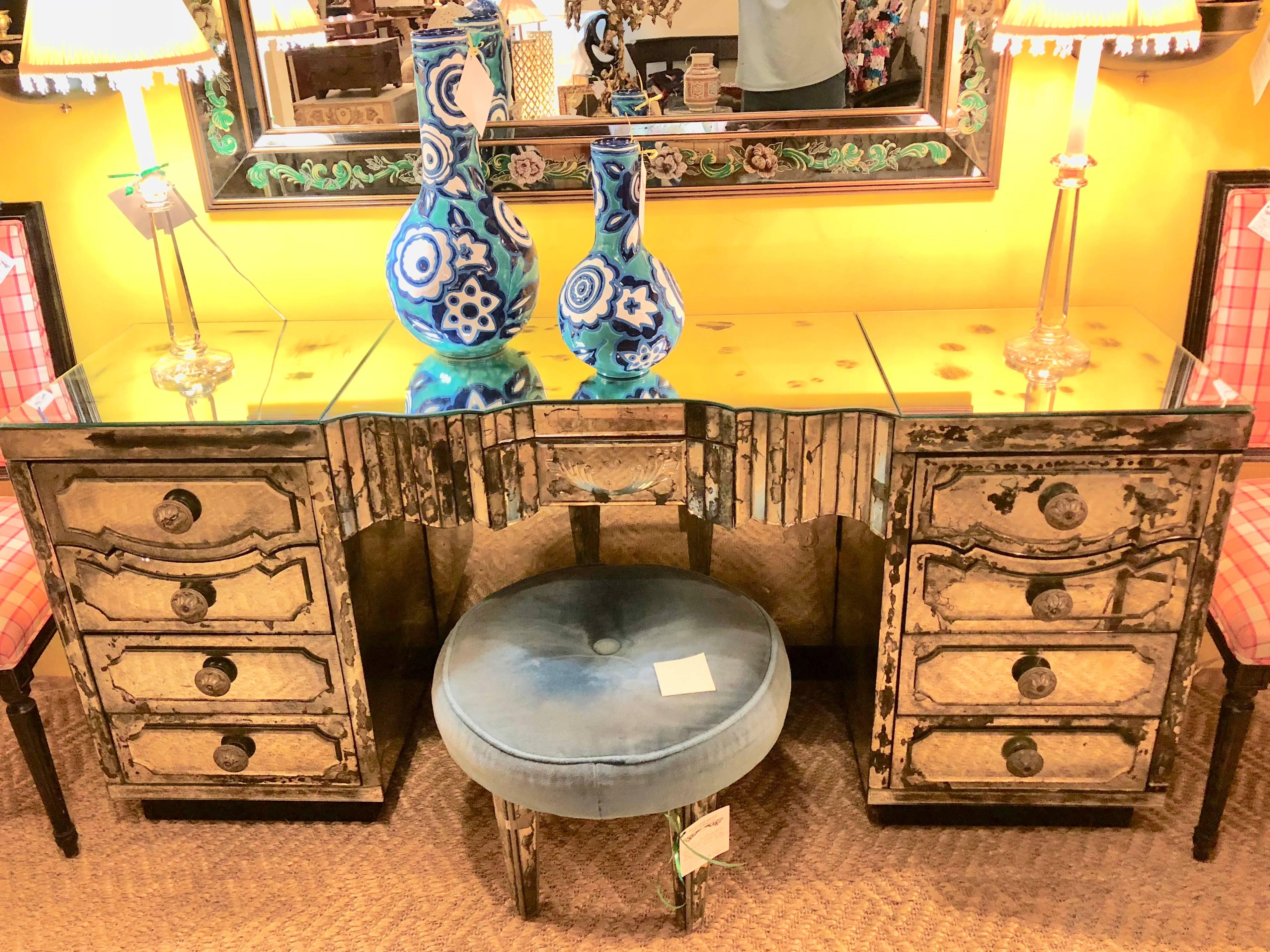 A Mid-Century Modern Maison Jansen Attributed Palatial Art Deco style mirrored vanity. All around bevelled mirror shine supreme on this early mirrored desk. The centre drawer flanked by a group of four by four drawers all double bevelled mirror