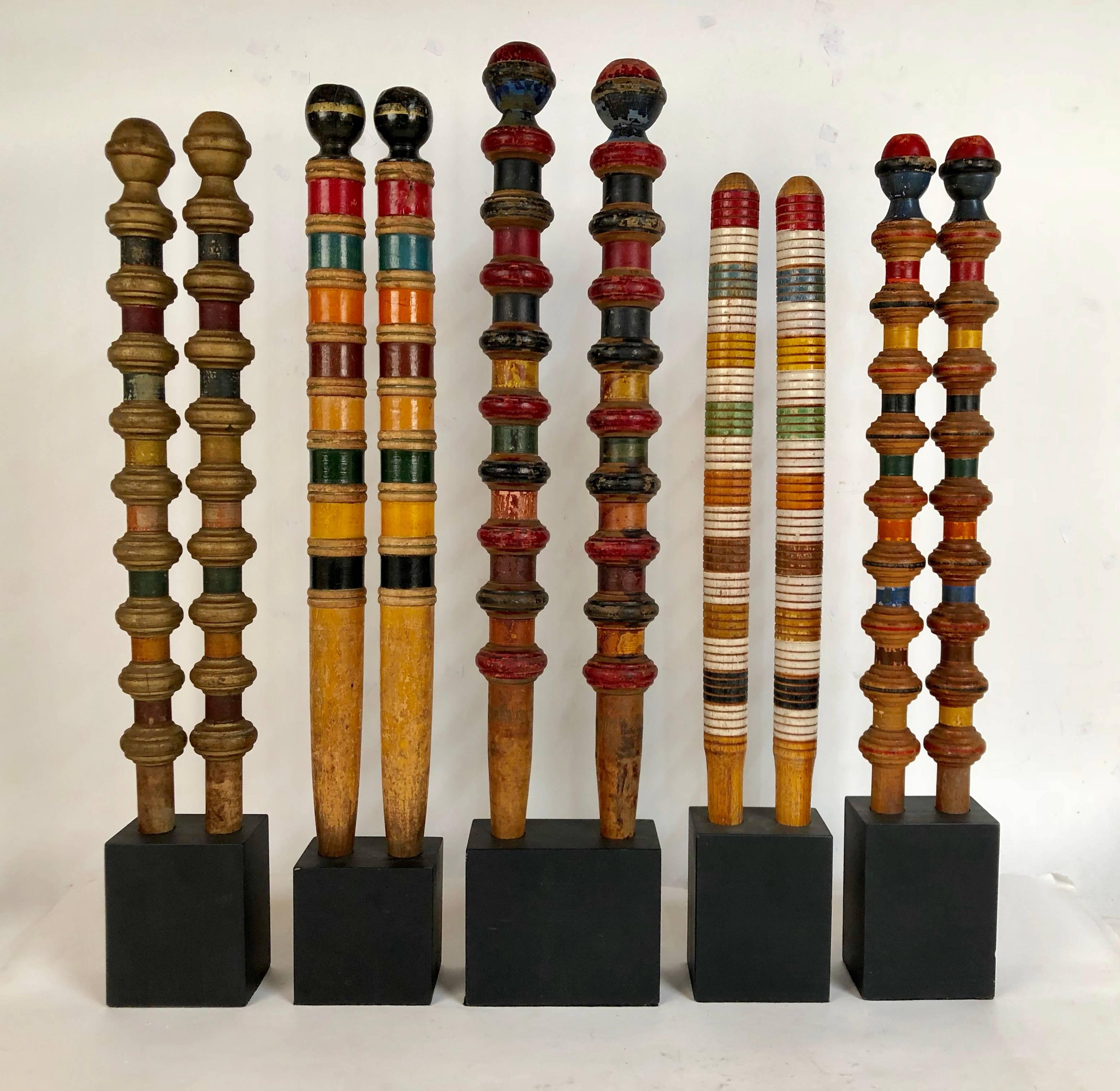 Collection of five pairs of antique and vintage colorful croquet posts in custom block stands. These are highly decorative with great detail in both color and shape. These range in age from 1880s-1930s. The tallest of these measure 27.75 x 5.63 x