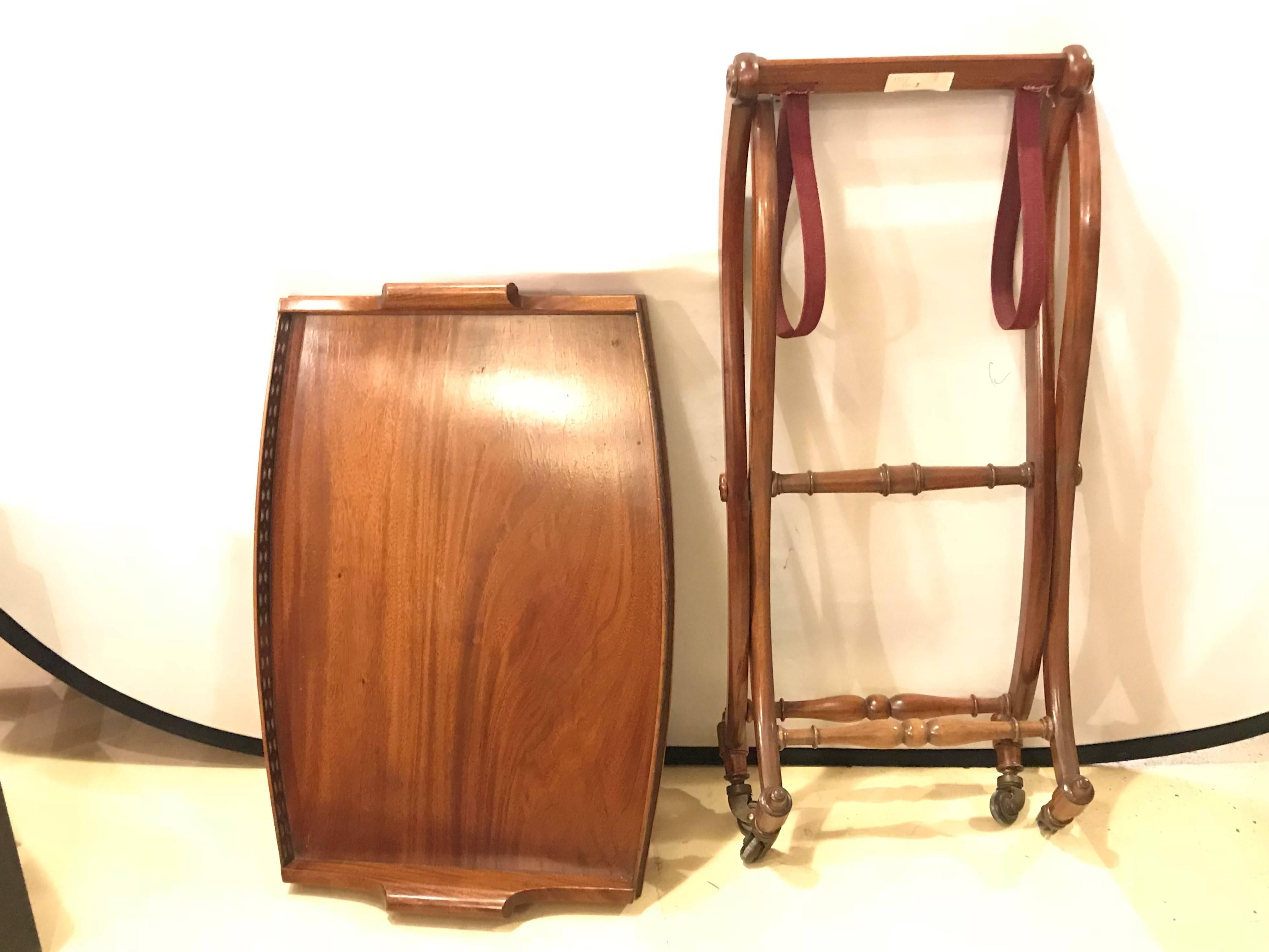 A mahogany Georgian style serving cart on casters with folding base.