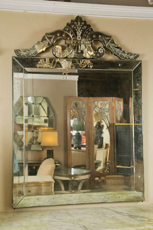 Pair of decorative Venetian style mirrors, 20th century, the square center glass with distressed paneling, the top adorned with a scrolled and shell-form crest with etched detail. Very beautiful!