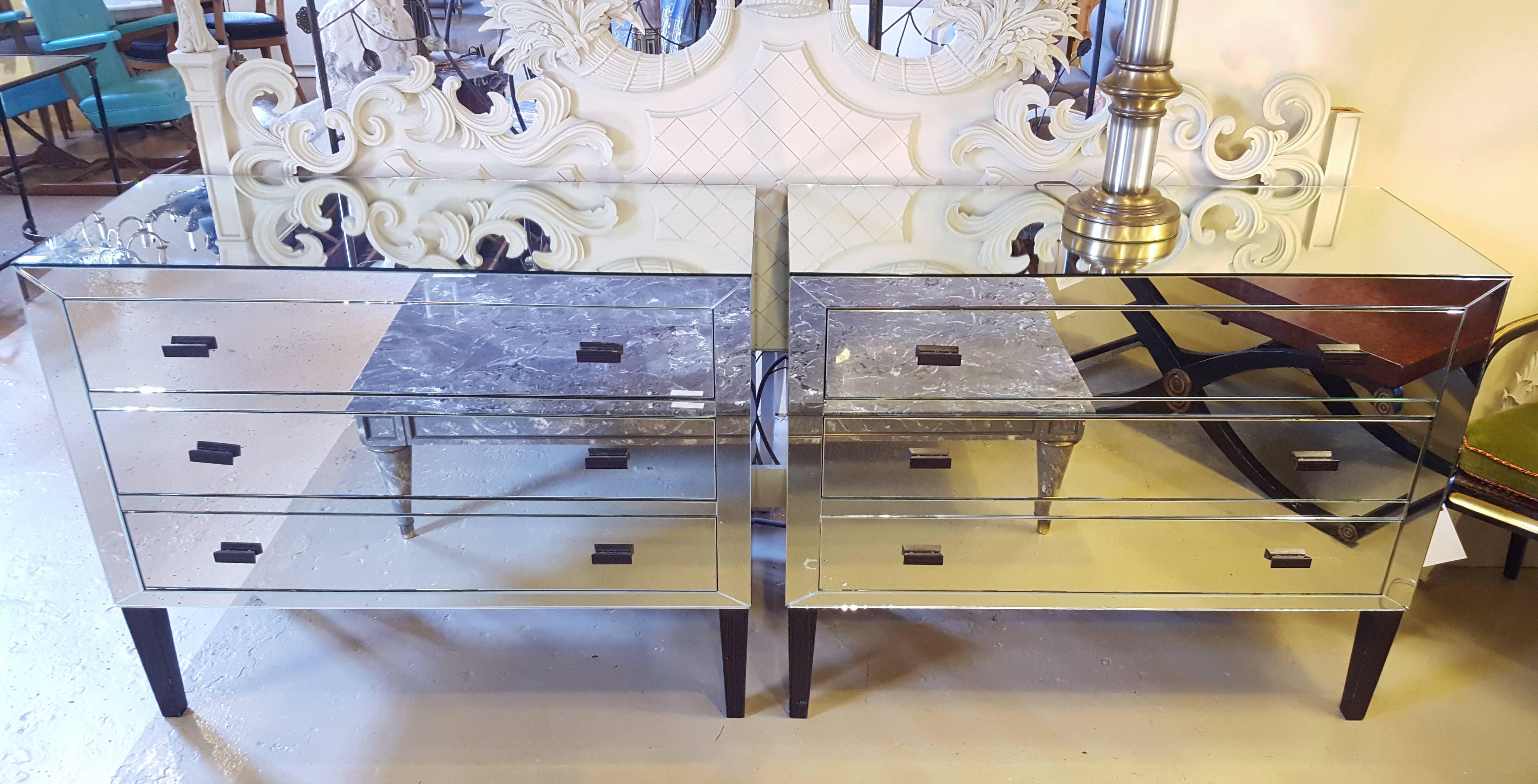Pair of fine Hollywood Regency custom quality mirrored commodes, chests or nightstands. This fine quality pair of 1970s mirrored commodes are very versatile as they can sit in and be used as many different pieces. Each having three mirrored drawers.