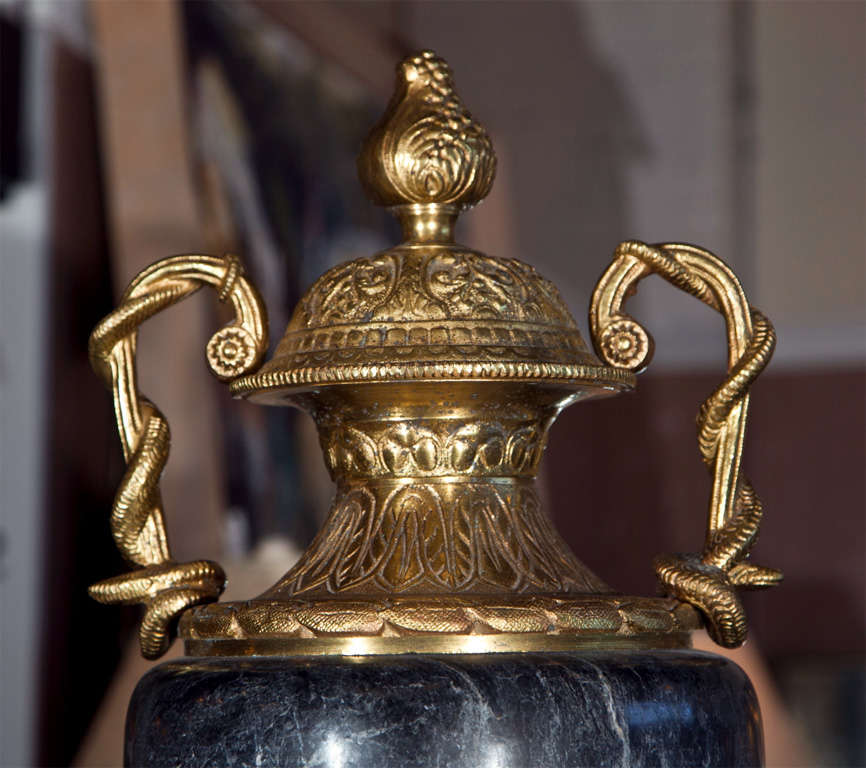 Pair of reproduction bronze and marble lidded cassolettes. Each dark grayish blue marble centre mounted on a finely cast bronze base and twin handled lidded top.