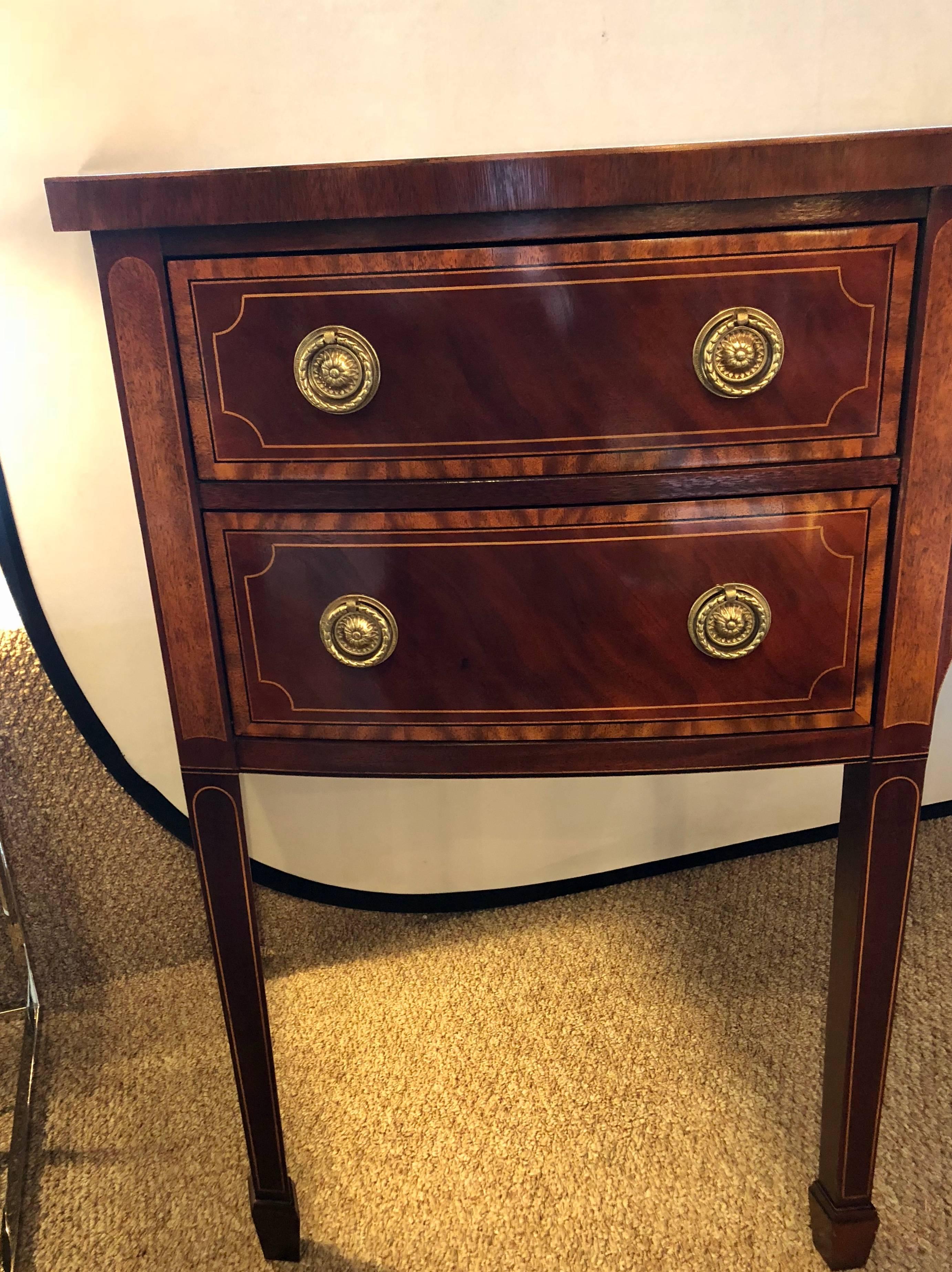 Mahogany and satinwood inlaid bow front sideboard by Baker Historic collection. This Fine custom quality sideboard is made by arguably one of the finest American furniture makers. Baker Furniture Company produced this Hepplewhite inspired sideboard