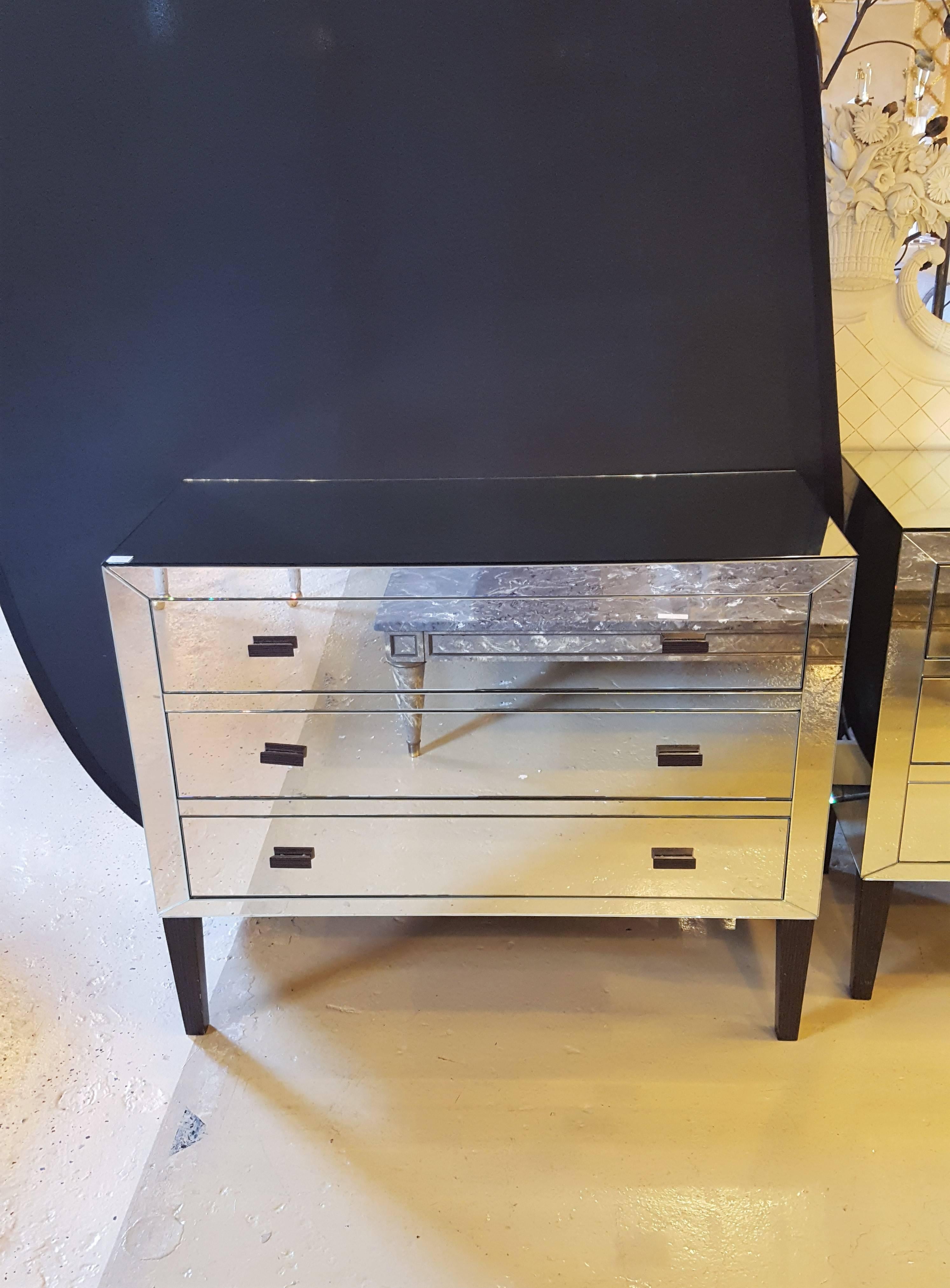 A fine Hollywood Regency custom quality mirrored commode, chest or nightstand. This fine quality 1970s mirrored commode is very versatile as it can sit in and be used as many different pieces. Having three mirrored drawers. Various scratches