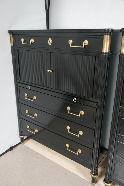 Pair of ebonized French Louis XVI style Jansen chests. This is a one of a kind pair of Maison Jansen chests. Each his and hers chest having bronze mounted feet supporting an upper body of three lower drawers with bronze pulls under a pull-out