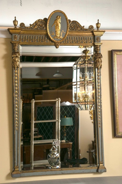 French parcel-gilt painted Swedish mirror with carved figures. This is a truly magnificent console or over the mantel mirror. The early 19th century original paint decorated and parcel water gilt frame in a celeste blue color with the finest carved