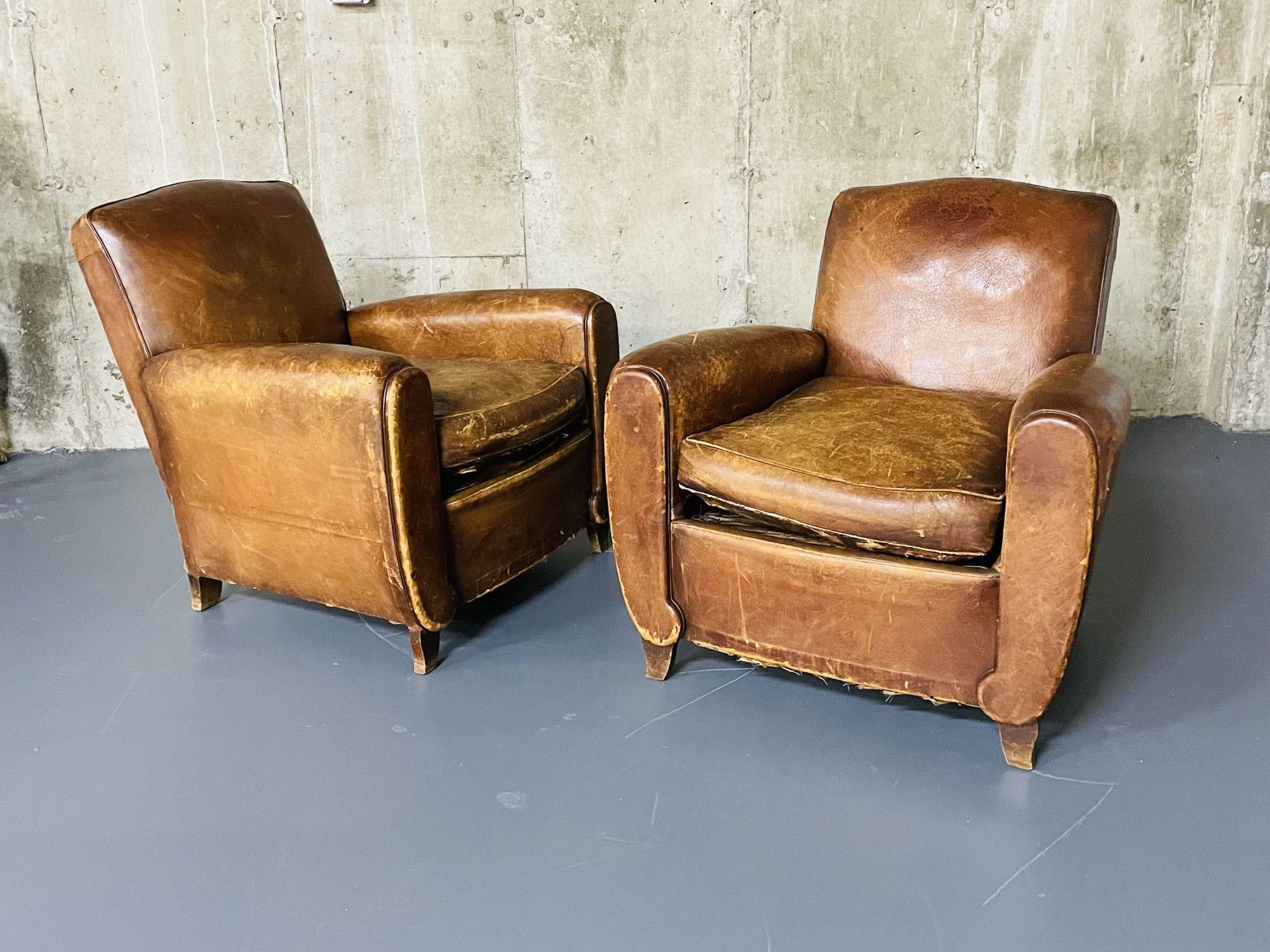 Pair of French Art Deco Distressed leather club / lounge chairs, Patinated
 
Fantastic pair of worn and distressed art deco original leather club chairs. No apparent tears in the surface of the leather. Original Air-Sea packing labels on underside