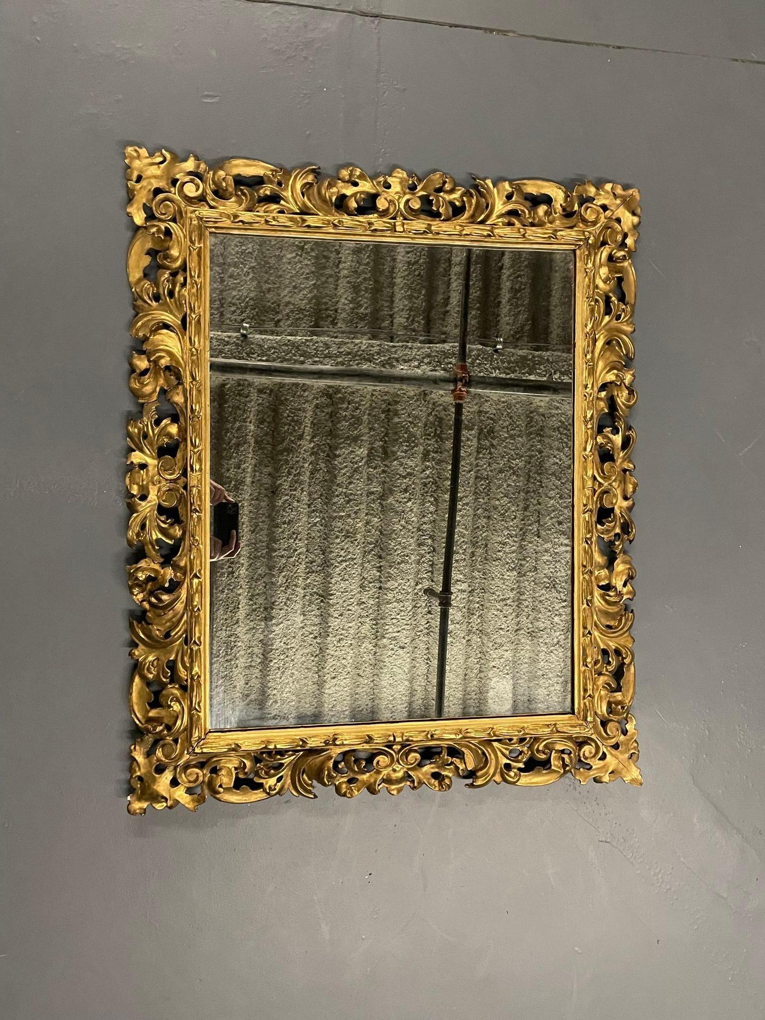 French intricately carved square wall / console / pier mirror, giltwood, 
A pierced finely carved wall or console mirror made of water gilt design housing a clean center mirror. This wonderfully carved mirror has a tag stating it is from A and F