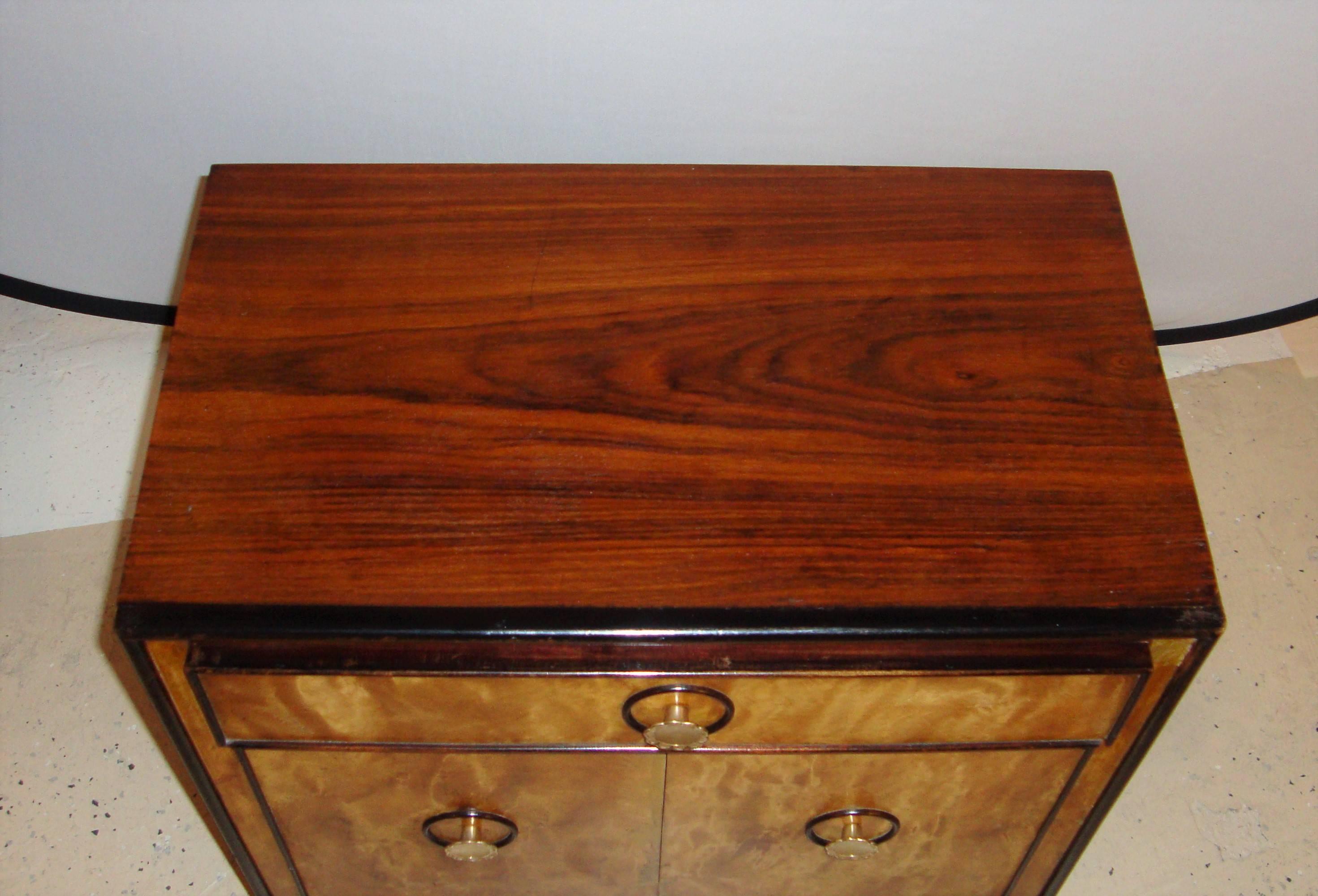 These Mid-Century Modern Asian inspired stands would look great along side a bed or sitting area. Each yew burl wood fronts and rosewood side with single drawers above double doors.