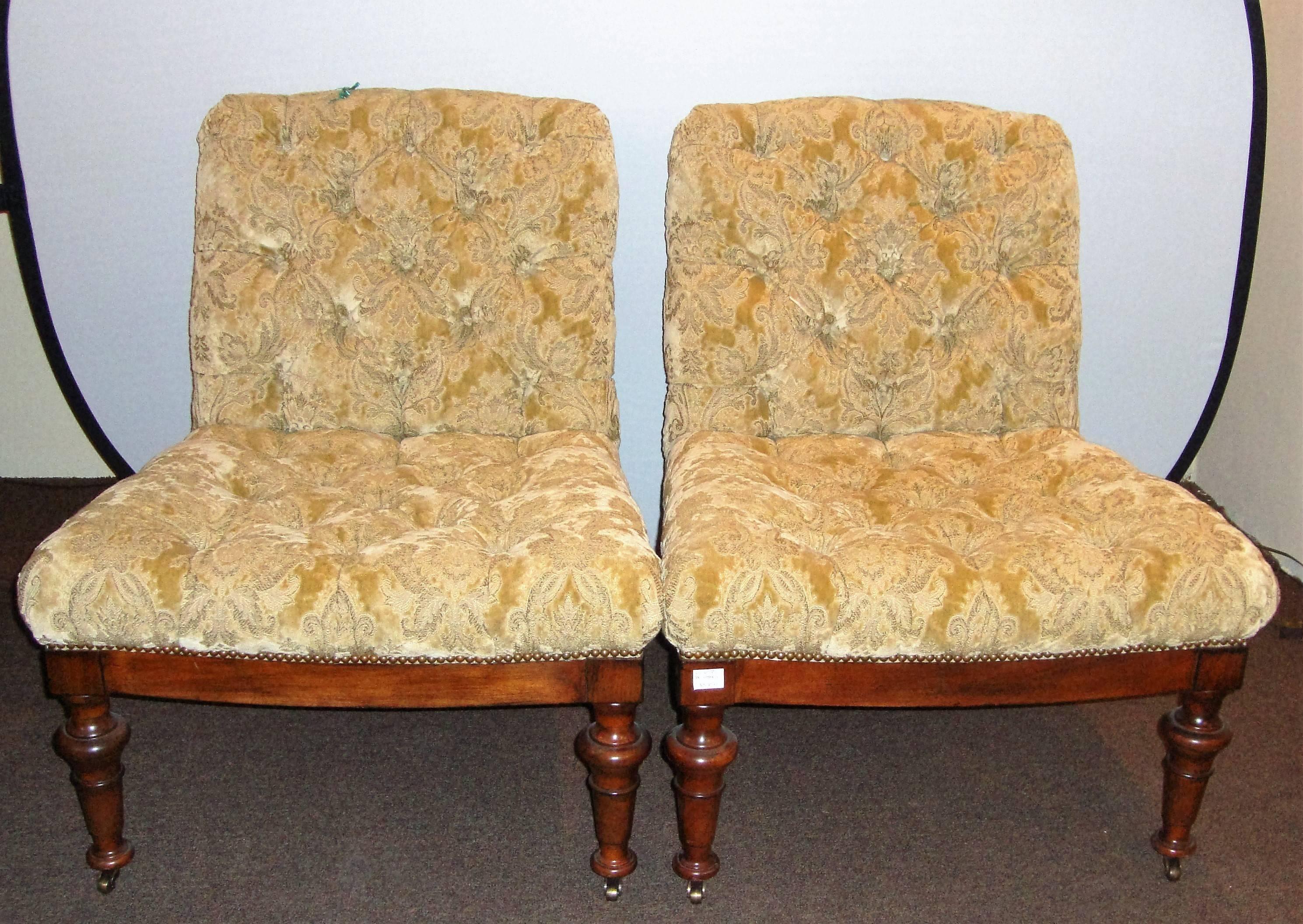 A pair of Edward Ferrell chairs sitting on a Victorian frames. These tufted, made in fine fabric velvet chairs is idyllic in its Classic shape. It is boldly postured as a stylish complementary piece for your room, its walnut legs sitting on wheels