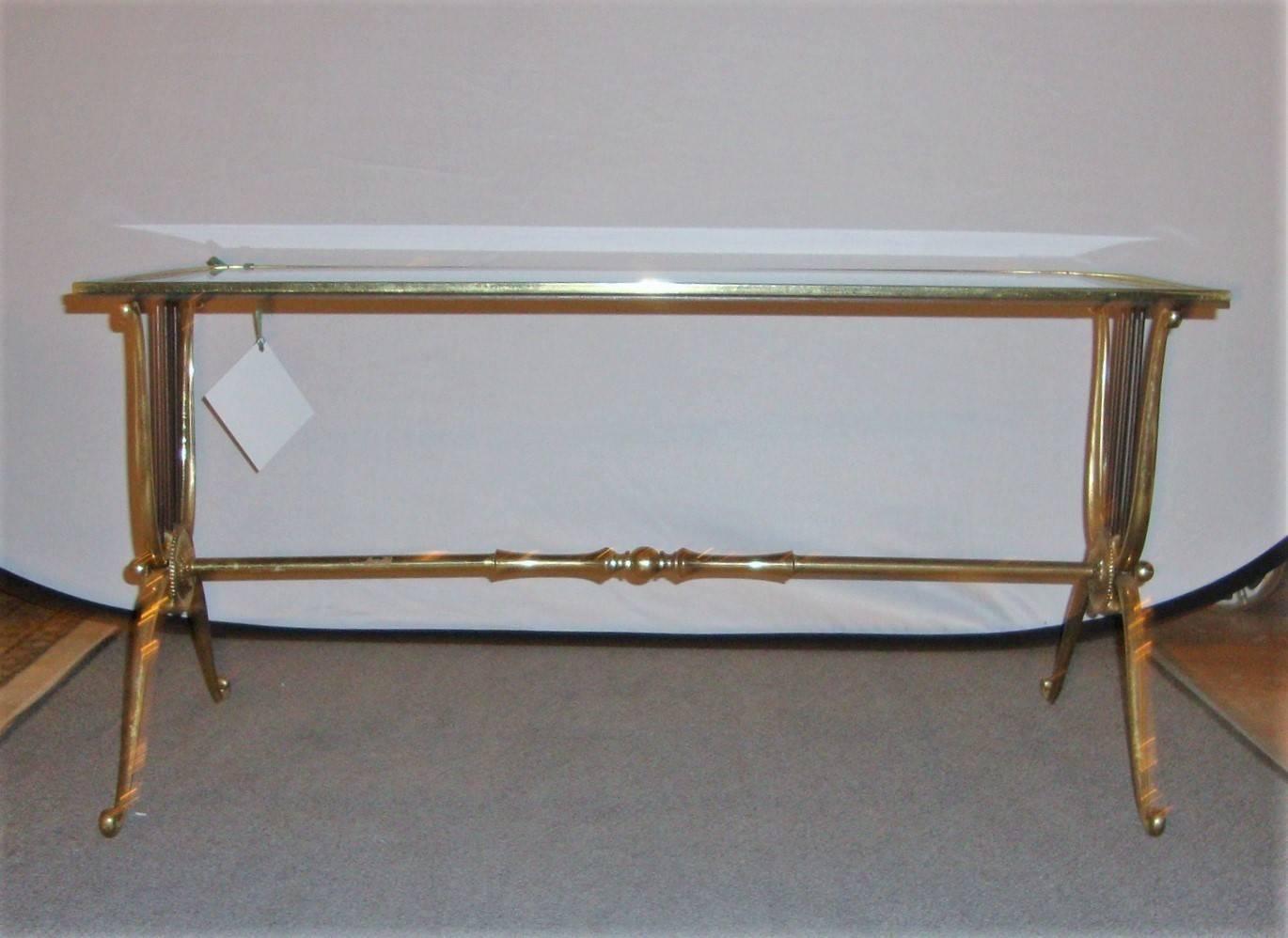 Maison Baguès bronze coffee table. Glass top with bronze base with base having harp shaped supports with Floret Centers. Piedmont style legs with scrolled feet.