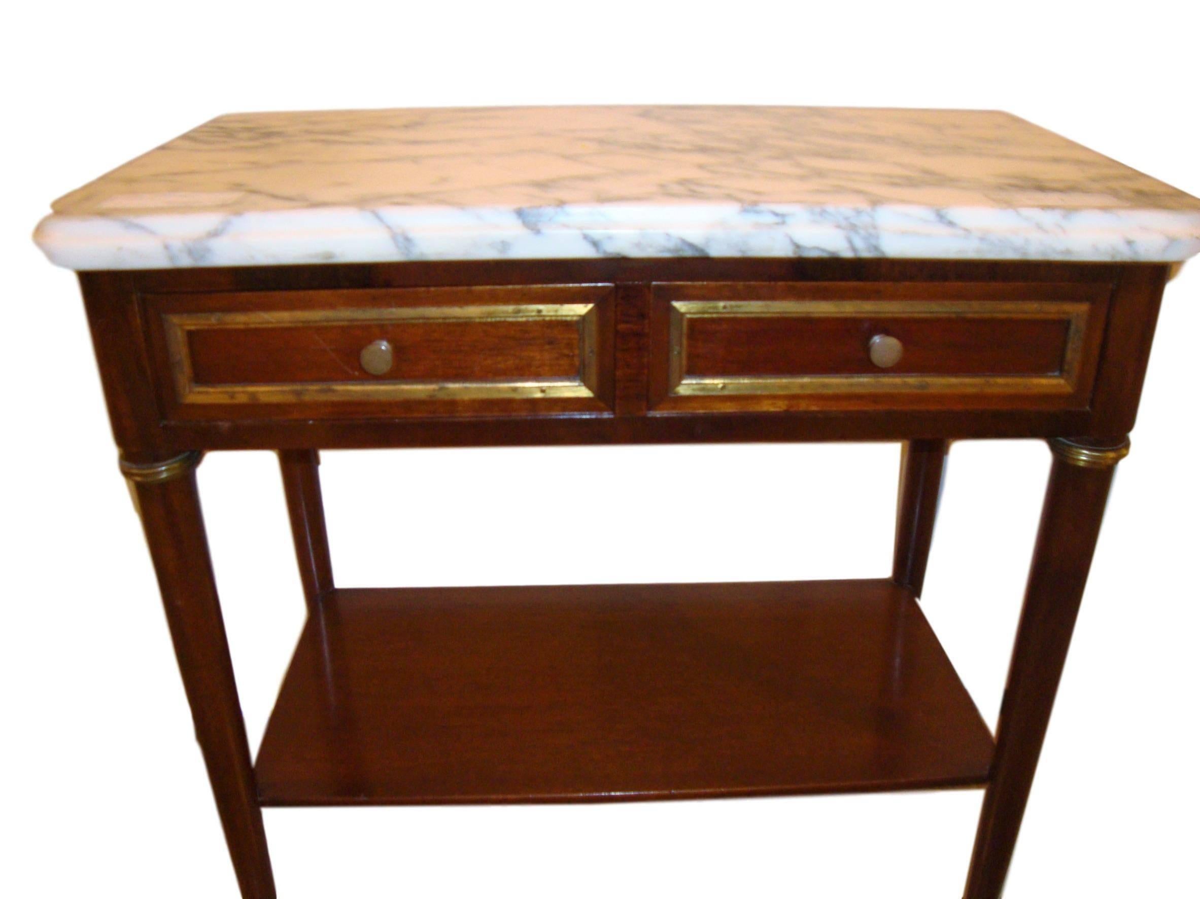 Diminutive mahogany marble top end table or stand manner Jansen. A Louis XVI style end table or stand with a white marble top and two drawers. 

Drawer length - 11inches