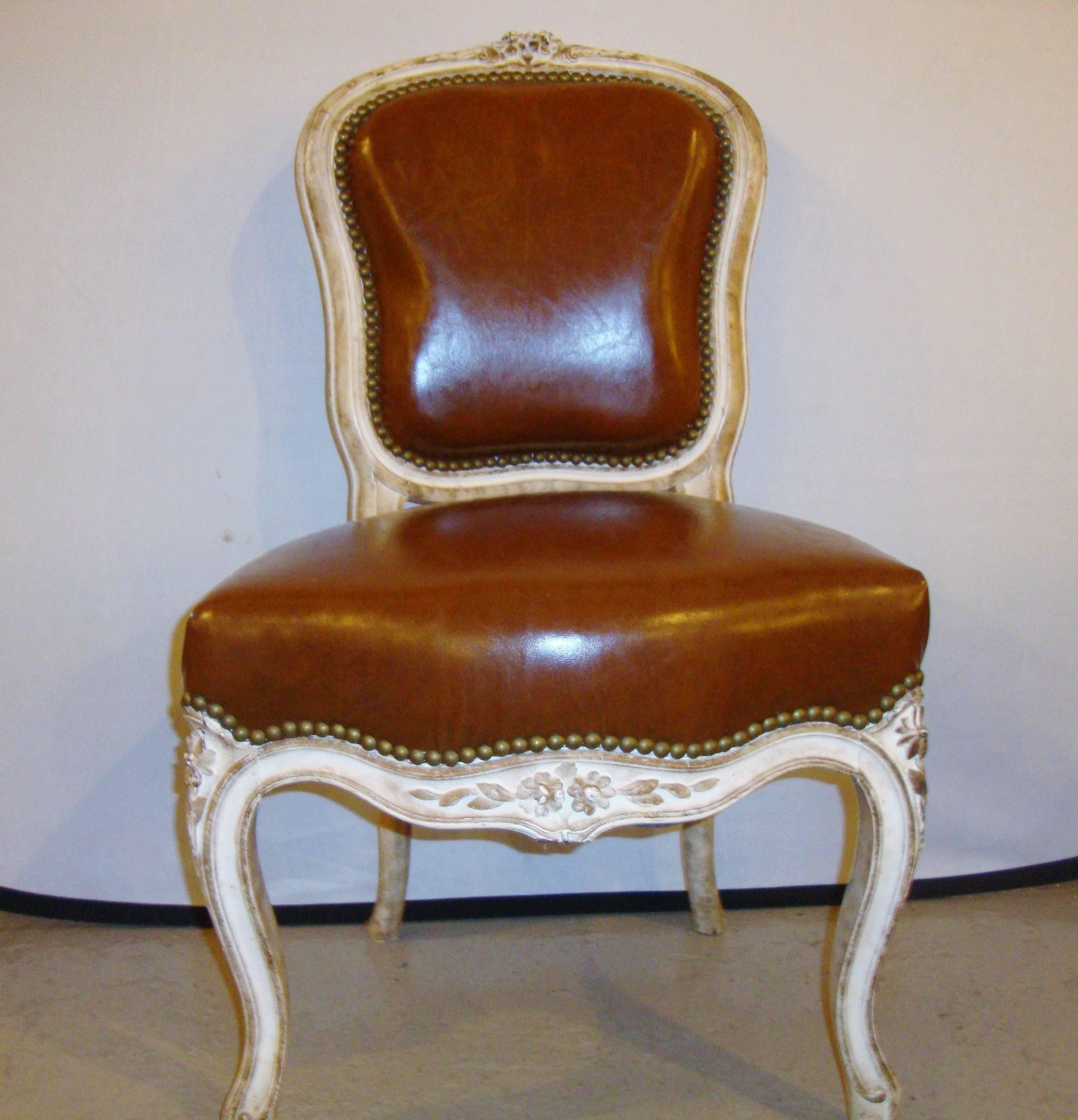 Diminutive leather and painted side chair by Jansen. This finely painted chairs is most likely made especially for a child of a wealthy family or as a salesmen model.