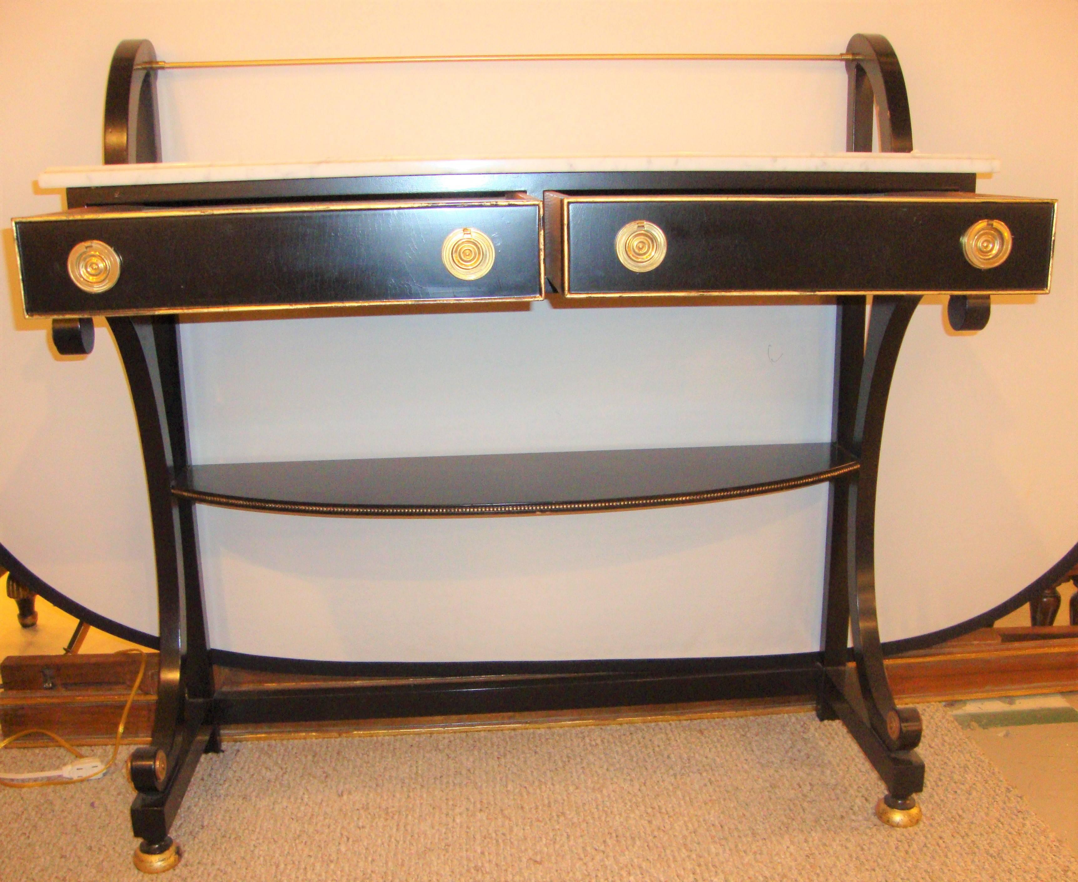 An ebonized marble-top server attributed Jansen. Having a pair of drawers with oak secondaries this finely ebonized server sideboard depicts the Hollywood Regency Era wonderfully. The case supporting a white marble top.