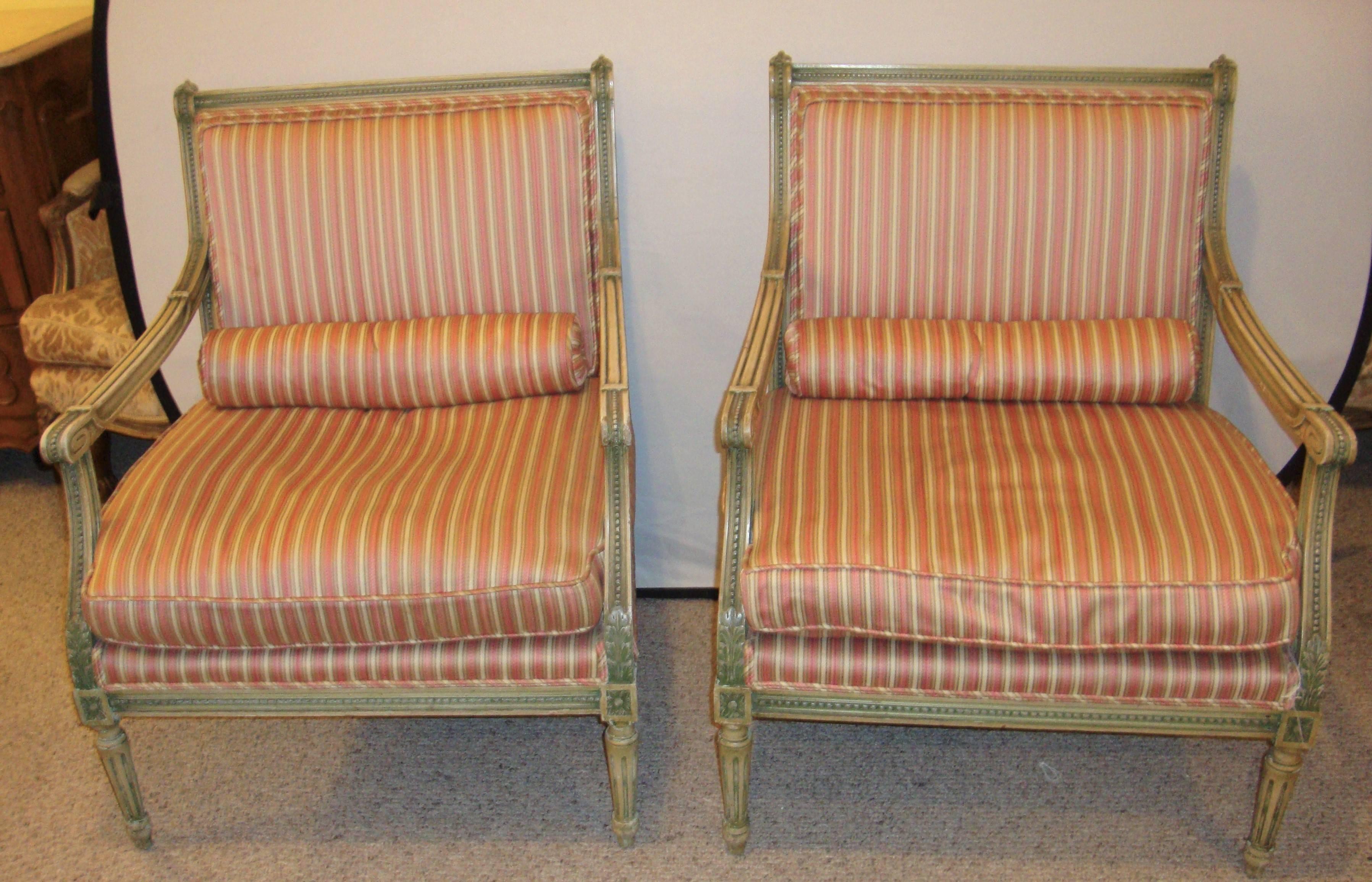 Pair of Louis XVI style Marquies by Maison Jansen. In an off-white gray greenish paint decorated frame with stripped upholstery.

Seat height: 17 inches.