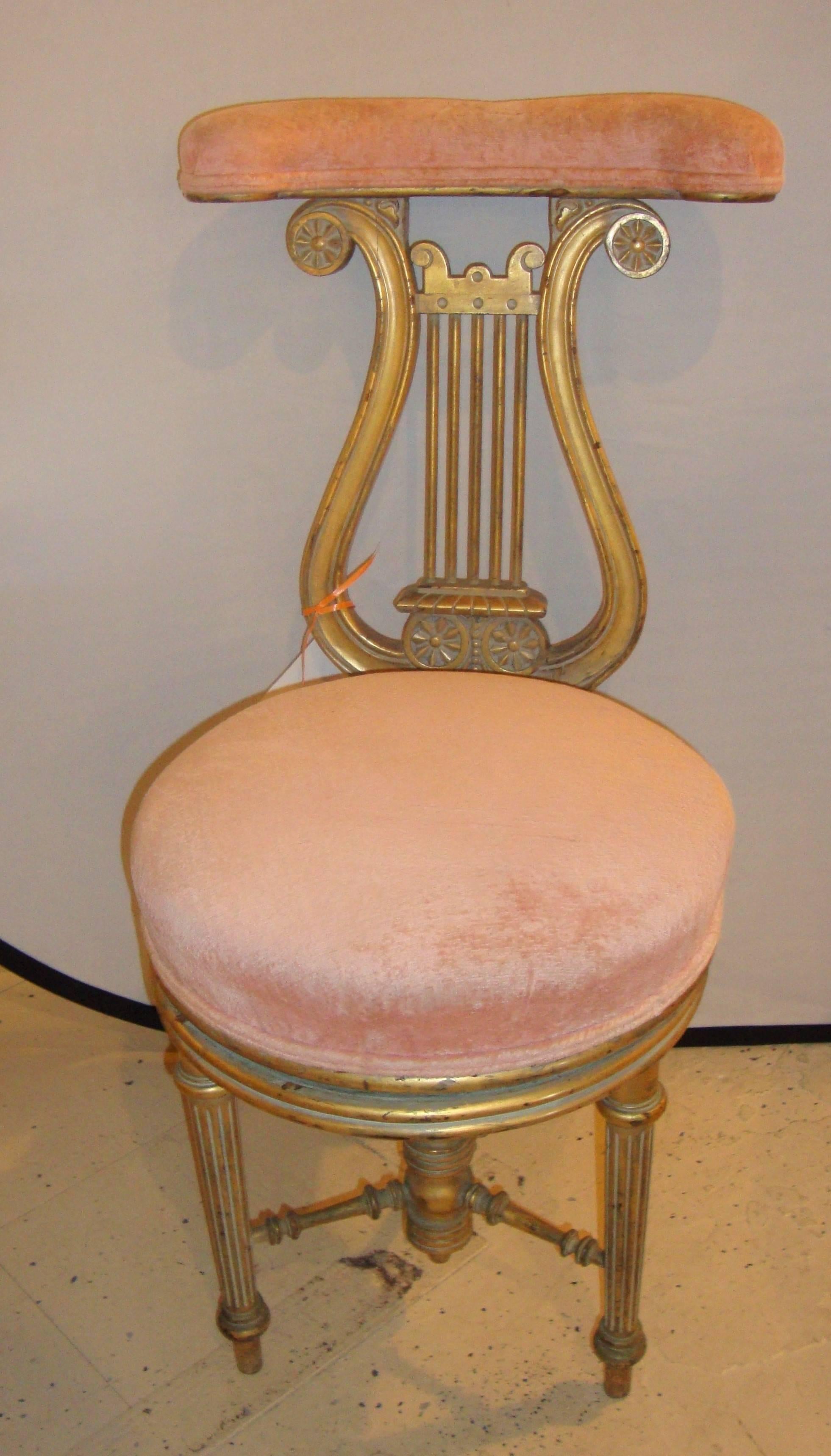 Victorian adjustable lyre gold harp piano chair.

Measures: Seat height 18 inches.