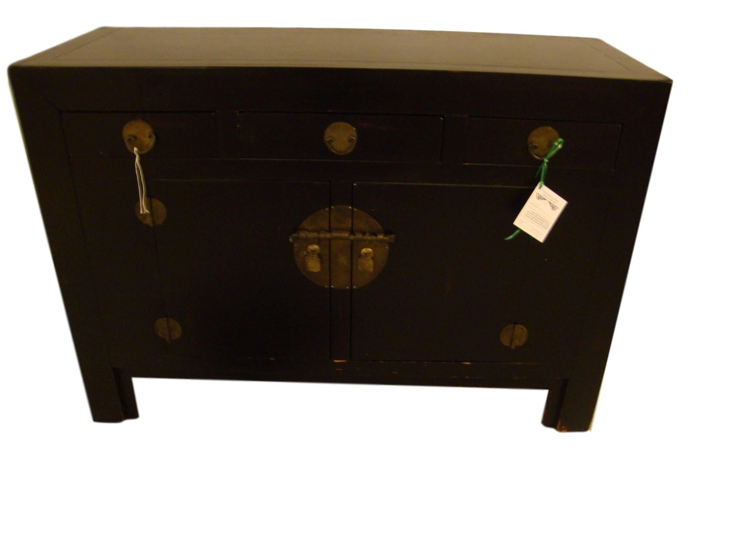 Ebonized Chinese style Campaign sideboard commode. Three top drawers, two cabinet doors and storage underneath. In a distressed finish.