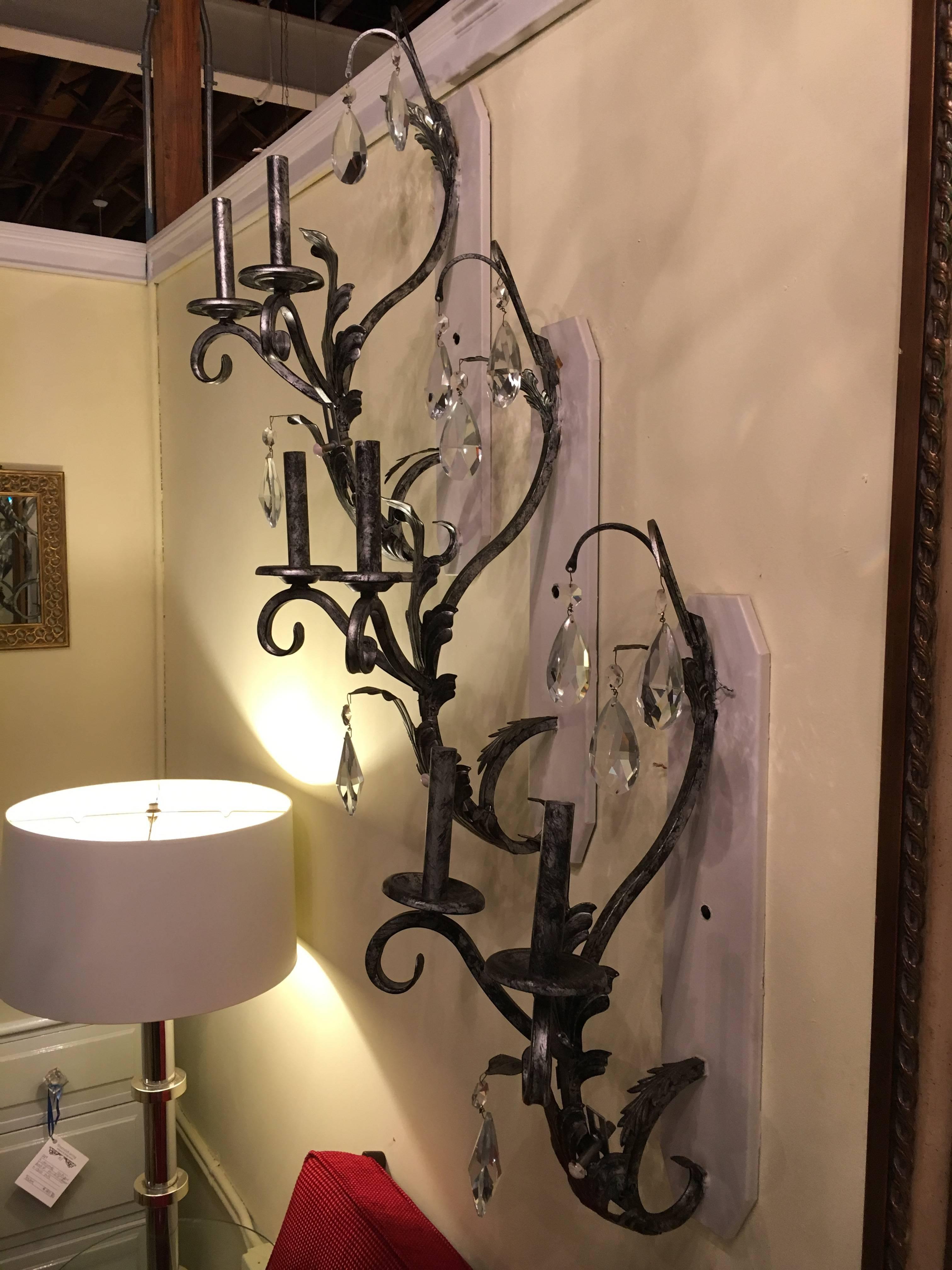 Set of six silver rustic two-light wall sconce by Schonbek. Each mounted on a metal back plate that is paint able and measures 23 inches by 4.5 inches. The fine hand-cut German crystals supported by a leaf and curved design sconce taking two 40