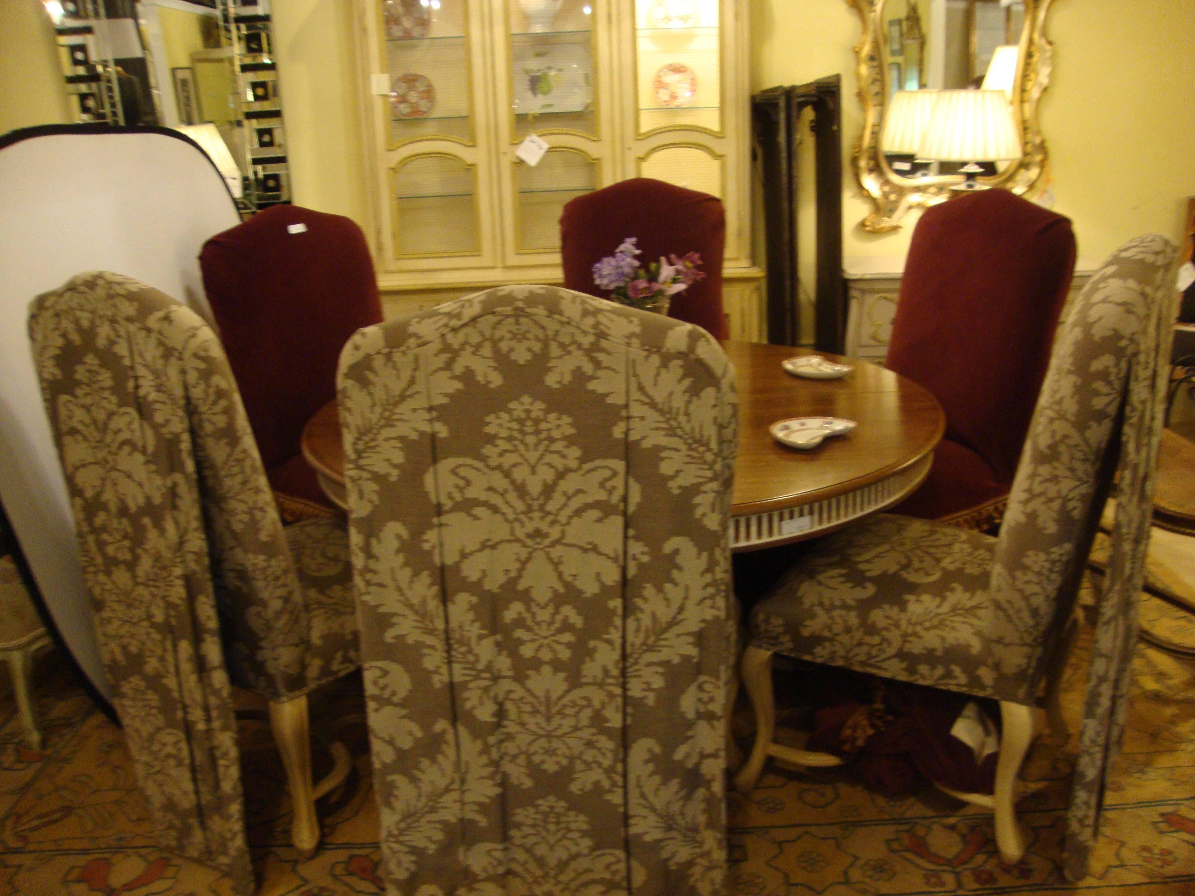 Set of six paint decorated hi back dining chairs. A fine set of paint decorated distressed dining chairs. Each having Queen Anne legs with crossed X undercarriage supporting a hi back of finely upholstered frames. The back rests having a drapery