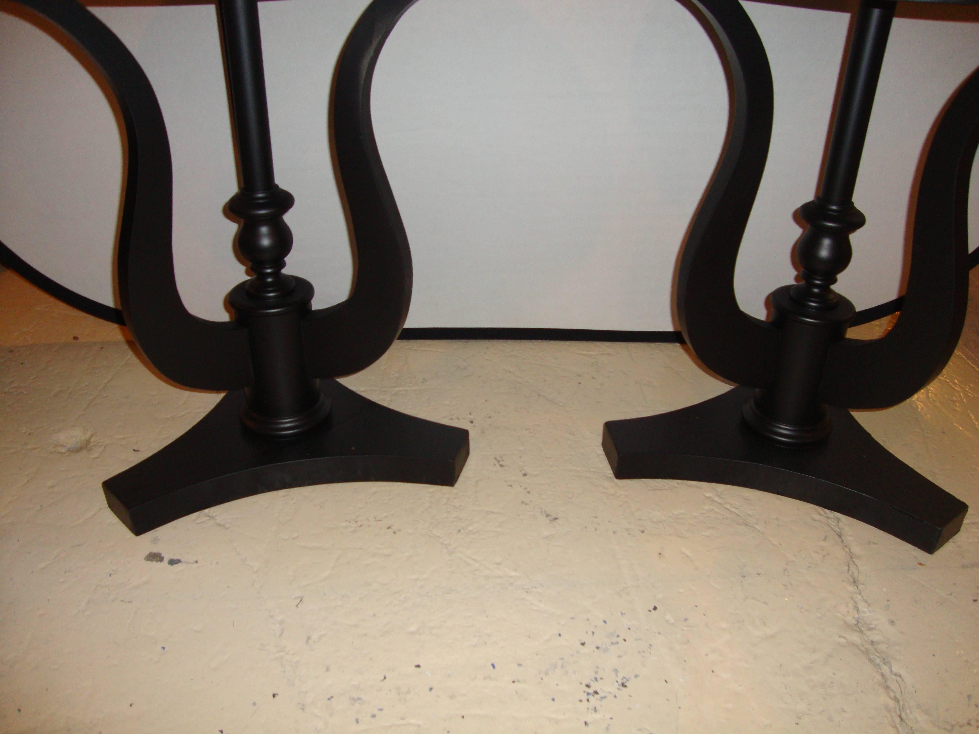Pair of Art Deco ebony based end tables with black marble tops, circa 1940s. Diameter: 26 inches.