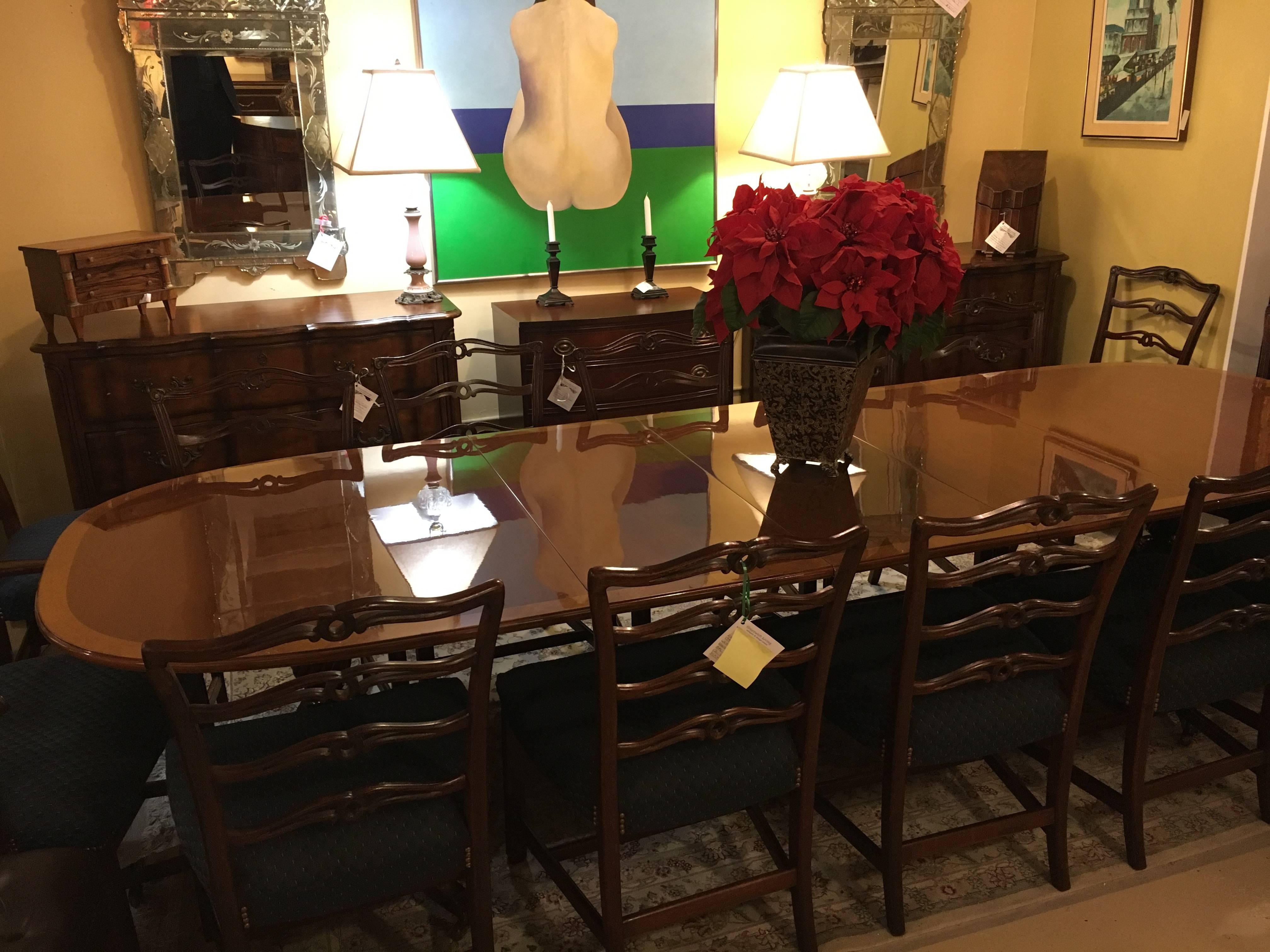 A Georgian style mahogany satinwood banded dining table with three (18 inch) leaves. A custom quality dining table most likely by Schmieg and Kotzian NY. The brass claw feet on casters leading into a double pedestal inlaid tripod pair of legs,