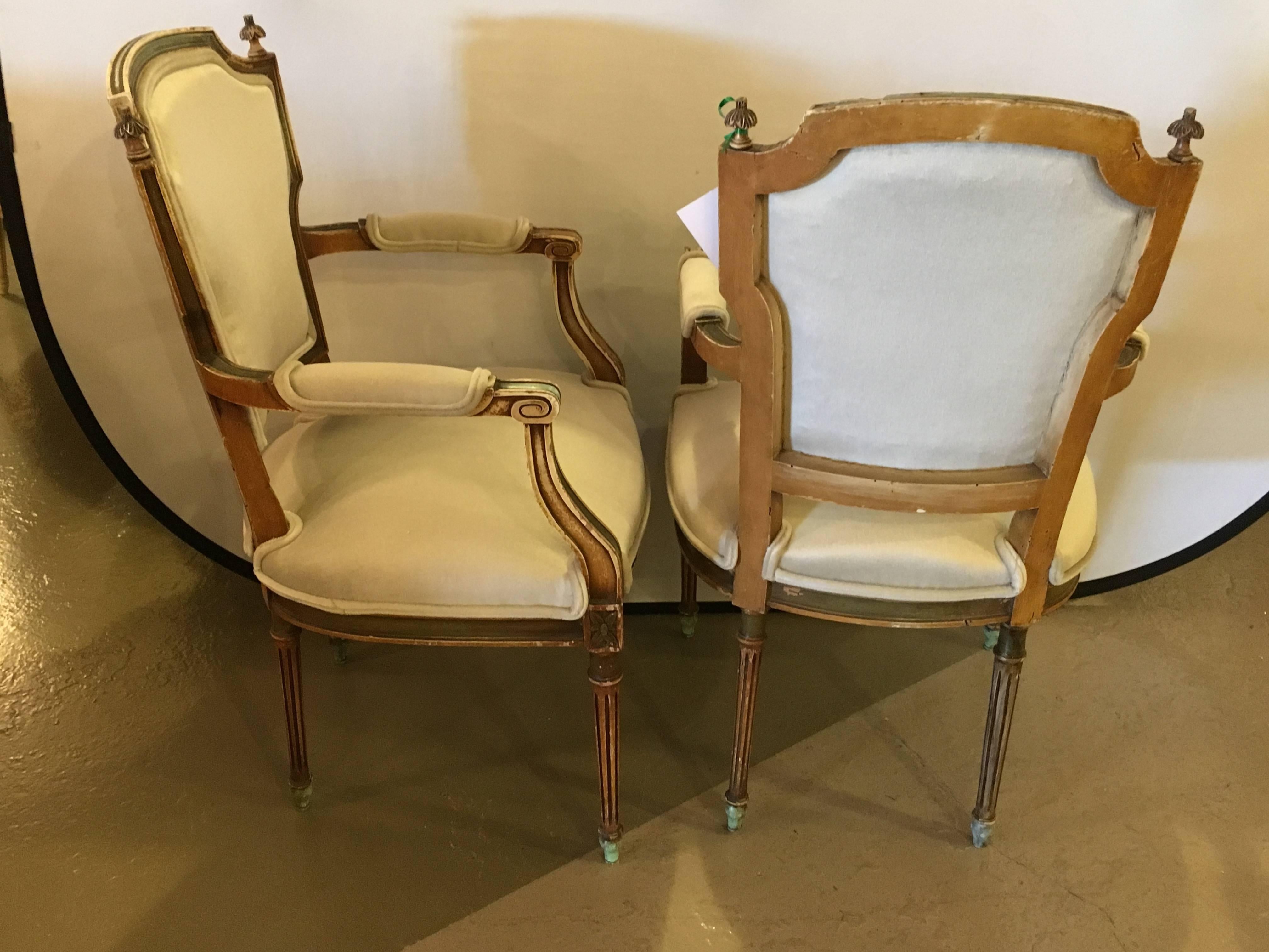 Maison Jansen stamped pair of distressed Louis XVI style armchairs. This fine pair of Jansen Fauteuils depict the Hollywood glamour ear wonderfully. Having a worn and distressed finish in new upholstery this set would look great in any setting home
